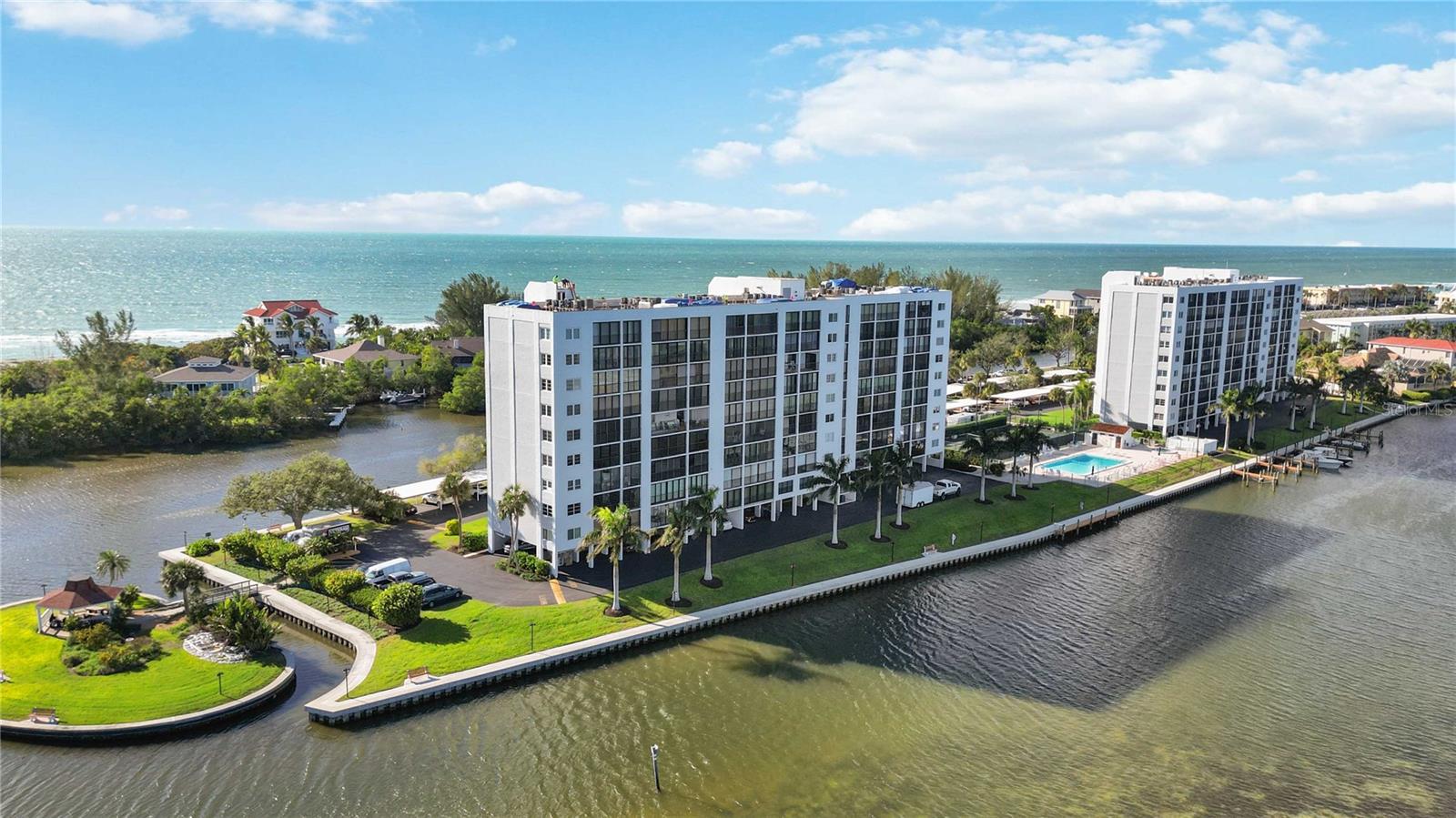 A lot of folks dream about living the ISLAND LIFE...well, NOW'S YOUR CHANCE! Join me in experiencing this stunning and renovated, 2 bed/2 bath condo, tucked away at the SOUTHERN MOST TIP of Siesta Key, Florida. From the moment you drive through the PRIVATE gates of The Pointe, you'll feel as though you've been transported to your own island getaway. As you pull into your ASSIGNED PARKING, smile and take note of your surroundings...the FRESH GULF AIR, mature and fresh TROPICAL LANDSCAPING, a group of paddle boarders floating by, boaters on their way home with a fresh catch, and the ever so frequent manatees and dolphins passing through! Head up to your 8TH FLOOR CONDO, where you'll want to pause and soak in some of the most beautiful UNOBSTRUCTED WATERFRONT VIEWS the island has to offer! The Gulf of Mexico, Little Sarasota Bay, and Jim Neville Nature Preserve can be enjoyed from nearly every room ~ sip your morning coffee while soaking in the SUNRISE OVER THE BAY, then later enjoy a cocktail while watching the EVENING SUNSETS OVER THE GULF! If a lifestyle is what you're after, you've come to the right place! Situated on 5 ACRES, amenities at The Pointe are sure to impress ~ offering a full time on site manager, CLUB HOUSE WITH KITCHEN, SPA, FITNESS ROOMS, HEATED LAP POOL, tennis / pickleball courts, kayak storage with launch, BOAT DOCKS with electricity and water, gazebo with grills, bike storage room, fishing, and community walking trail. Renovations to your new home are plentiful ~ from a NEW ROOF (to be completed in the next couple of weeks), IMPACT WIDOWS AND DOORS, NEW AC in 2020, quartz counters, tile backsplash, CUSTOM CABINETRY IN THE KITCHEN / UNDER BAR TOP, stainless steel under-mount sink and hardware, LUXURY PORCELAIN flooring throughout, designer light fixtures and RECESSED LED, built-in wine fridge, and GLASS SHOWER with elegantly tiled niche are just a few of the upgrades! You'll appreciate the oversized master bedroom, fully accessible with custom designed closet, and direct access to an enclosed 25x8 air conditioned lanai and laundry room overlooking the bay. Guests may never leave, as they enjoy the built-in Murphy Bed and desk, perfectly positioned to enjoy Gulf Views! Be sure to view our property video and webpage in the web links attached! FURNITURE MAY BE AVAILABLE FOR PURCHASE on a separate bill of sale. **The Pointe is located minutes from Turtle Beach, multiple restaurants, world famous Siesta Key Beach and Siesta Key Village. Structural Integrity Reserve Study and Milestone Inspection Reports are done!!**