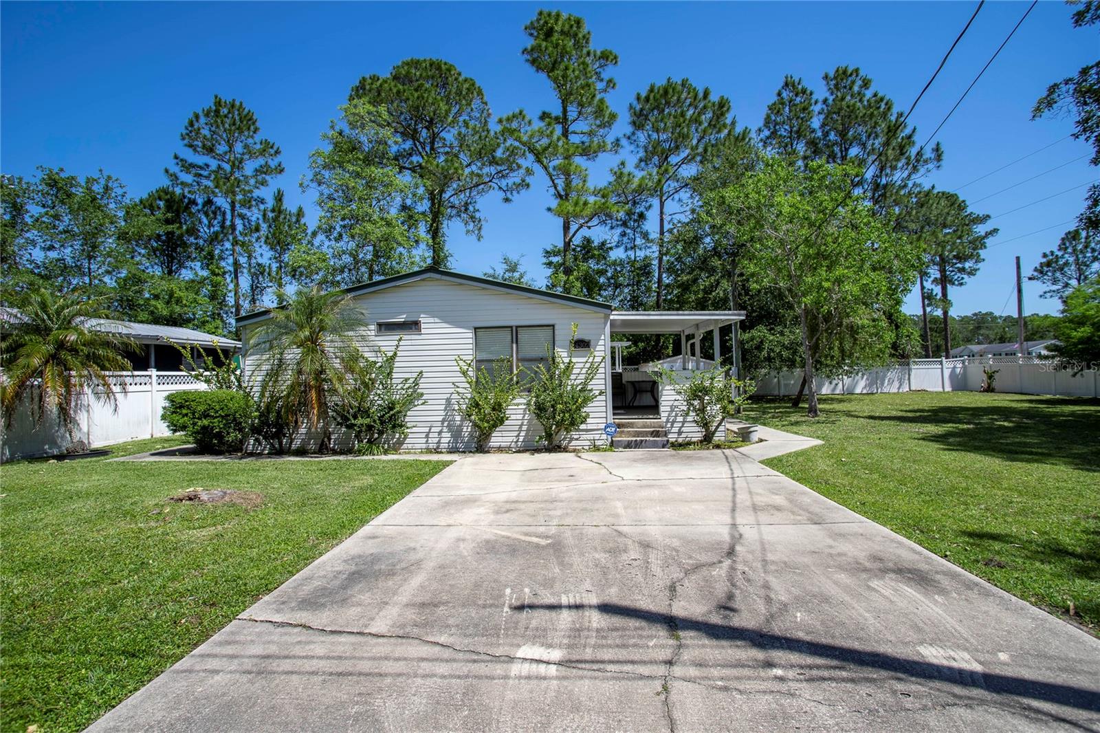 Pride of ownership shows in this beautiful, completely furnished double-wide tucked away in the heart of Astor...NO HOA!!! The house was completely re-plumbed, including a new water heater, in June 2023. If you love fishing, boating, and peace and quiet -- this is the home for you! Several boat ramps are nearby, and you are a short distance from the St. John's River. Take a boat ride, and you may find yourself on the Atlantic Ocean with nothing but open seas and blue skies all around you! This home sits on a double corner lot that is fenced. A/C is about 7 years old, and the metal roof is about 5 years old. There is also a shed on the property with electricity -- this can be perfect storage or a workshop. It's up to you. This home has so many possibilities! This is the perfect home for seasonal residents or year-round folks who want to move right in and begin living the Florida lifestyle -- convenient to recreation areas and a quick walk to the library. Termite bond transferable to the new owner -- could be you! Don't wait! Schedule your tour today and make this home your own.