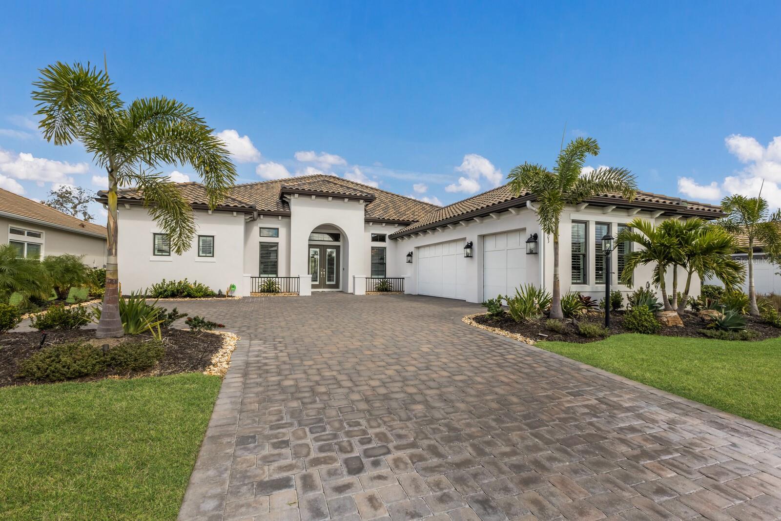 Live the Florida dream in this BETTER THAN NEW executive home with GOLF MEMBERSHIP on a private conservation lot with golf course views! This highly sought-after Beacon floorplan is no longer available in Azario & features EXCEPTIONAL curb appeal & UNMATCHED LUXURY. With 3 bedrooms, 3.5 bathrooms, & a 3-car garage, this elegant smart home is designed for STYLE and COMFORT. The gorgeous pool, spa, & extended covered outdoor living space w/oversized outdoor kitchen provides the ULTIMATE in Florida living! The inviting Mediterranean elevation draws you in & the view through the sliders to your outdoor paradise is nothing short of SPECTACULAR. Soaring 12-foot tray ceilings create a sense of grandeur, while the elegant study off the foyer offers a private retreat. The open formal dining room includes a pass-through BUTLER'S BUFFET, seamlessly connecting to the kitchen. Beyond the foyer is the HUGE gathering room, which truly impresses with its gas fireplace & elegant built-in feature wall w/lighted uppers, perfect for showcasing your decor! The gathering room opens to your GOURMET DESIGNER kitchen featuring top-of-the-line GE Monogram appliances, French-door double oven, lighted upper cabinets, natural gas cooktop w/griddle, designer vent hood, added roll-out drawers in cabinets + more. A casual nook just off the kitchen offers panoramic views of your backyard while you sip your morning coffee & enjoy a delicious meal. Sliders from the gathering room lead you to the ULTIMATE SHOWSTOPPER - your SPARKLING saltwater pool & spa that overlooks the private preserve, with a view of the golf course just beyond! The oversized pool & spa feature a heater & sun shelf, and the extended lanai is an ENTERTAINER'S DREAM with a large outdoor kitchen & ample seating at the bar, perfect for backyard parties! The expansive PRIMARY SUITE is located at the back of the home, offering peaceful views of your backyard. The spa-like DELUXE primary bathroom includes garden tub, walk-in shower w/glass enclosure, extended vanity w/dual sinks, & TWO HUGE walk-in closets with CUSTOM built-in shelving. Each of the generously sized guest suites includes walk-in closet & EN-SUITE bathroom, one of which doubles as a pool bath. A half bath for guests is situated at the front of the home, with spacious laundry room & convenient drop zone just outside. The laundry room includes upper & lower cabinets, utility sink, & plenty of counter space for folding all of your clothing & linens! Garage includes impact windows, epoxy floors, an EV outlet for electric vehicles, & added insulation in the garage door & in the ceiling above the garage & mini-split to keep this area nice & cool! Other upgrades include BRAND NEW Zinga hurricane shade for lanai/back of home; NEW plantation shutters throughout; NEW whole home generator with soft start for AC; NEW custom closets throughout; whole-home/lanai WiFi extenders; in-ceiling speakers; security cameras; NEW upgraded landscaping w/lighting; & more. Located in gated Esplanade at Azario at Lakewood Ranch, this home enjoys access to world-class amenities including 18-hole championship golf course; clubhouse w/ lifestyle director; NEW Culinary Center for fine dining, wine tasting, cooking classes & events; Bahama Bar restaurant for poolside dining & cocktails; wellness center/spa; fitness center; tennis/pickleball/bocce courts & more. Prime location in award-winning Lakewood Ranch.
