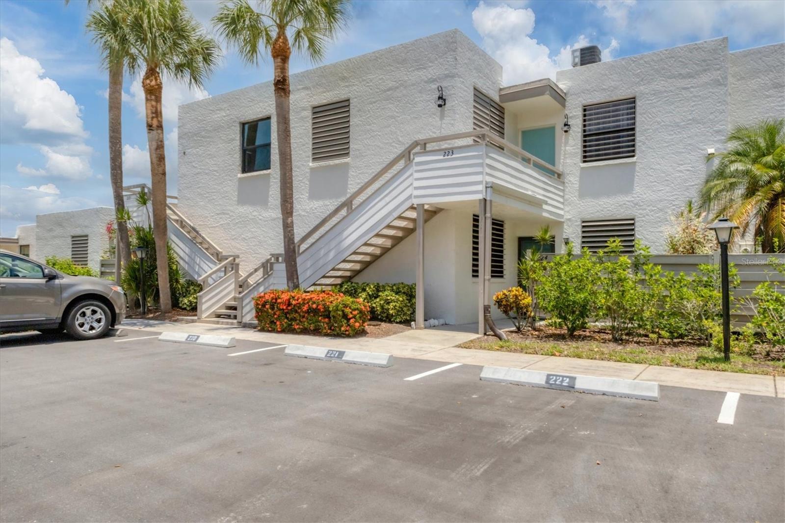 One or more photo(s) has been virtually staged. Welcome to the beautiful, quiet community of Wildwood Springs and enjoy the lush tropical landscaping of this 88 acre bird and wildlife sanctuary with your own piece of paradise. This community offers lifestyle living with resort style amenities including pools, hot tubs, tennis and pickleball courts and great areas for walking or bicycling. This two bedroom, two bath ground floor condo offers a gorgeous view overlooking the lake from the large enclosed lanai. Plenty of storage, tile and laminate flooring throughout, and A/C was installed in Fall 2022. Covered carport parking as well as another assigned parking place and plenty of guest parking for your friends and family. Conveniently located to beaches, restaurants and shopping. Call today for your private showing, you'll be glad you did!