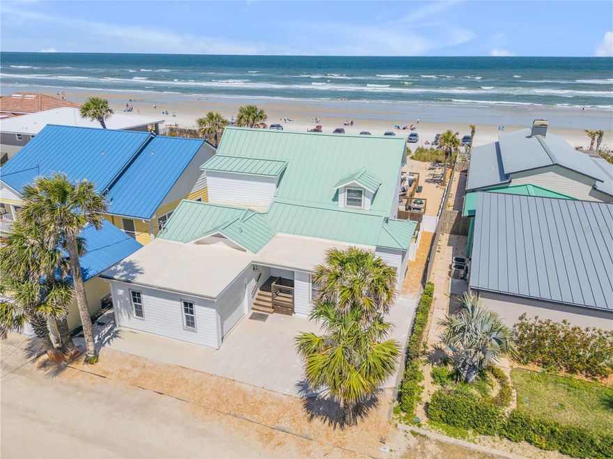 Direct oceanfront Vacation Rental Zoned Cape Cod style renovated Seafarer's Cottage.  Renovated to be in keeping with the 1930's style and fully furnished.  Central Beach Location only two blocks to shops, dining, and groceries.  Spectacular direct ocean views from most rooms and master bedroom.  Furnished home features heart pine hardwood floors with white plank-wood and beam ceilings and plantation shutters on every window.  Metal roof and Tropical landscaping.  Saltwater heated pool and spa on enormous 50'x 40' Brazilian IPE deck with table-top gas fire pit, large EGG grill, and outdoor shower.  Huge 22'x23' Primary bedroom.  Upstairs has vaulted ceilings and multiple sliding glass doors to a private ocean-sunrise-view deck.  Large primary bath features spa tub, private shower, bidet, walk-in closet, laundry closet, and glass sliding door to private primary oceanfront deck.  Two additional beautifully appointed bedrooms and additional bathrooms are located on the main level downstairs.  Again Short Term Rental Zone with excellent, professionally managed vacation-rental history to generate income.