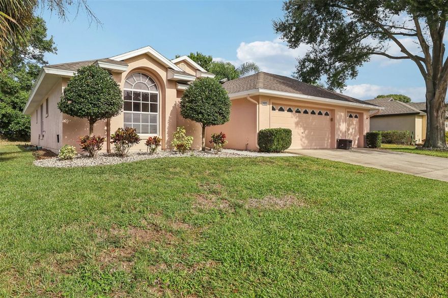 One or more photo(s) has been virtually staged. Freshly painted and well cared for, this move-in-ready 3-bedroom, 2-bath residence offers an open, airy layout with vaulted ceilings that bathe the interior in light. The heart of the home is the kitchen, complete with a center island, built-in desk, and pantry, perfect for meal prep and organization. A bay-window breakfast nook overlooks the private backyard, offering a serene spot for morning coffee or casual dining. The large primary bedroom is a relaxing retreat with backyard views, a walk-in closet, and an ensuite bath with dual sinks. At the front of the home, a secondary bedroom with vaulted ceilings provides a welcoming space for guests, while the versatile third bedroom with French doors easily serves as an office, craft room, or den. Step outside to enjoy Florida living on the covered lanai or screened-in birdcage patio, ideal for unwinding or entertaining. The oversized 2-car garage includes extra space for a golf cart, motorcycle, or workshop. Recent updates bring lasting peace of mind, including a new roof (2023), replumbing (2023), HVAC (2019), and water heater (2022). This smart home features light switches compatible with Alexa and energy-efficient LED lighting. Residents enjoy a gym, pool, and fitness center, while Tavares’ lakefront restaurants, live music, Wooton Park events, and nearby boating and recreation at Hickory Point Park are just minutes away.