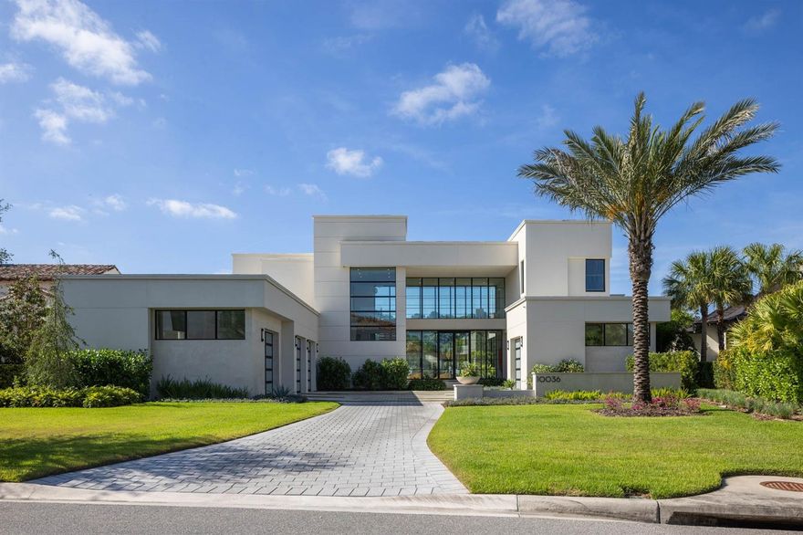 Step inside a modern marvel nestled within the exclusive enclave of Walt Disney World's Golden Oak neighborhood. Poised on over half an acre, this 2023-built residence redefines upscale living with its sleek design, sophisticated details, and private setting. Upon entry, your gaze is drawn through a vast expanse of floor-to-ceiling glass to the oversized pool and spa, a breathtaking centerpiece that sets the tone for this unique home. The main level is a masterclass in contemporary elegance and functionality. The gourmet kitchen is both refined and innovative, featuring a hidden prep kitchen, a full wine fridge flanked by the refrigerator and freezer with cabinet-level finishes, waterfall-edge island counters, an eight-burner professional stove, and a pot filler that blends practicality with artistry. The first-floor primary suite is a haven of luxury, offering a spa-inspired bath with a freestanding soaking tub, steam shower, and dual vanities. With private access to the pool area and an expansive, custom-designed walk-in closet, this retreat exudes the thoughtful precision of bespoke craftsmanship. Beyond the main residence, the detached office impresses with a full bath, custom built ins, and a showcase garage with dramatic floor-to-ceiling windows. A standalone gym provides a dedicated space for wellness, complete with athletic flooring, serene views, and direct access to the lanai and pool area. Outdoors, the home transforms into a personal retreat. The elongated pool, spa, and sun shelf are framed by over 1,000 square feet of covered living space, complemented by a fully equipped grill station, ideal for both intimate gatherings and grand entertaining. The second floor continues the experience with three full ensuite bedrooms and a versatile flex room, perfect for a home theater or game room. Additional features include an elevator, a main-level parlor with a wet bar and a striking backlit onyx countertop, warm hardwood flooring throughout, an oversized laundry room, custom lighting package, and countless other meticulously curated details. As a resident of Golden Oak, enjoy exclusive access to Club Life, including concierge services, private transportation to the parks, signature events, and immersive theme park experiences. Offered partially furnished, with a curated list of furnishings available upon request, this home invites you to live a life of unparalleled elegance and enchantment.