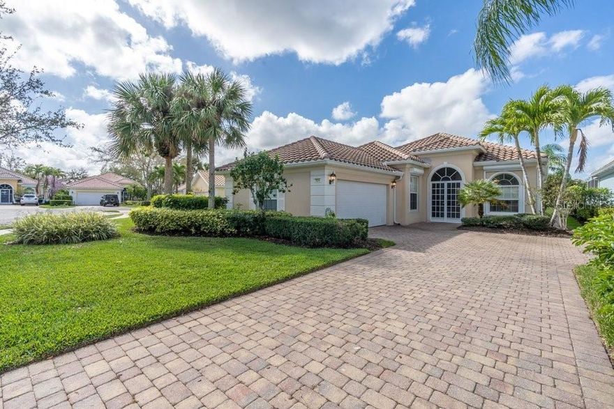 Located in the wonderful community of Verona Walk, this pristine, turnkey furnished home makes a great first impression the moment you arrive. Lush landscaping, mature palms, a paver driveway, and a classic tile roof all add to the attractive curb appeal. An enclosed front porch welcomes you in, with beautiful arched French doors leading into the home. Inside the foyer you’ll notice the high ceilings and bright, airy feel right away, with neutral paint tones and plenty of natural light throughout. Just off the entry is a den that would make an ideal home office, conveniently connected to the kitchen. The kitchen offers white cabinetry, Corian countertops, and opens to the main living and dining areas. Large sliding doors bring in lots of light and provide a nice view of the pool area out back. The dining area offers plenty of space for gatherings, and the living room features built-in cabinetry and additional sliding doors leading to the patio and pool. The home has a comfortable split bedroom layout, with two nicely sized guest bedrooms and a full bath on one side of the home and the spacious primary suite privately located on the other. The primary bedroom includes sliding doors to the patio, two walk-in closets, and a large bath with dual vanities, a shower, and a relaxing garden tub. Additional features include an indoor laundry room with cabinetry and a utility sink, along with direct access to the attached two-car garage. The home is also equipped with electric hurricane shutters that can be closed with the push of a button for added convenience and peace of mind. Out back, the screened enclosure offers a covered patio area, an above-ground spa, and a private in-ground pool, with a hedge just beyond the screen that adds an extra sense of privacy—an ideal setting to enjoy the Florida lifestyle. Motivated seller!
