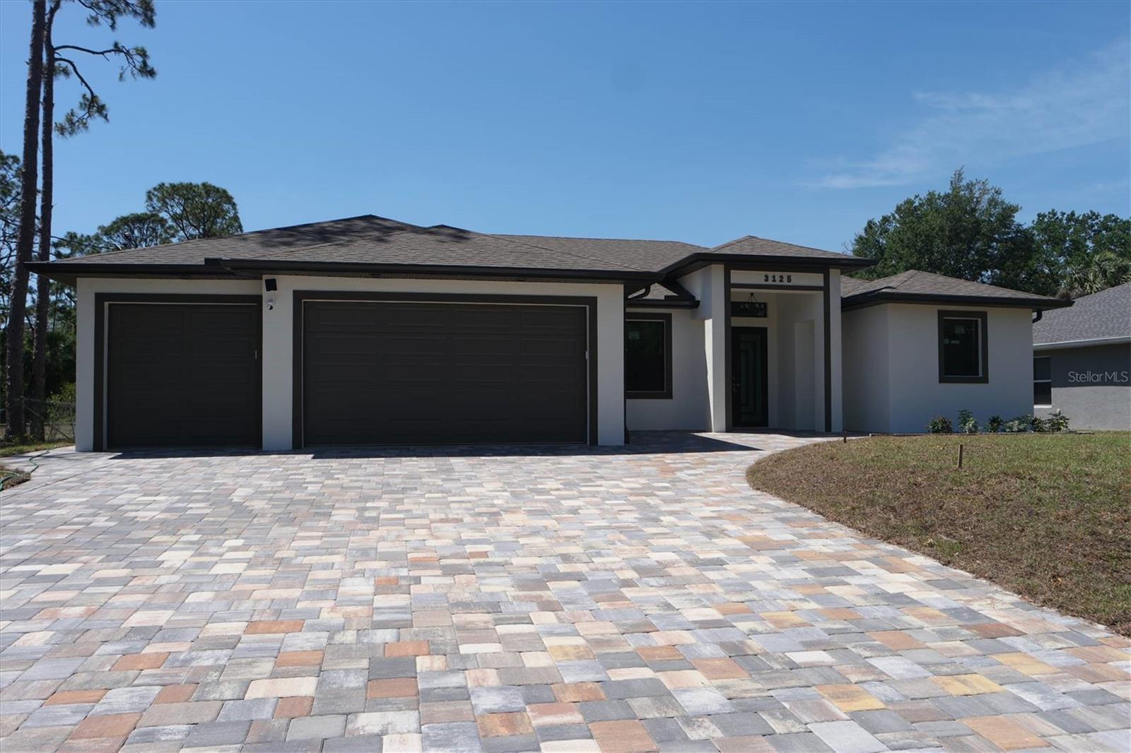 Welcome to your own piece of paradise situated in the heart of the city on the green belt. This luxurious custom-built brand-new home with a 3-car garage and a dream driveway is complete and ready to move in! The minute you walk in you will see excellent attention to the details and fall in love with the beautiful kitchen. Kitchen features upgraded kitchen cabinets with the stainless-steel appliances, beverage fridge and cooler, and build in oven and microwave combo. The flooring throughout the house is luxury vinyl flooring. Hurricane proof impact windows and doors. Enjoy beginning of each day with a great cup of coffee on your oversized lanai overlooking the green belt that is just made for the friends and family gatherings. There are no details spared on this beautiful house with so many upgrades, such us free standing tub in the masters, ample storage space, upgraded AC to Lenox, all light fixtures come with remote control, 8ft door throughout, and much more.
