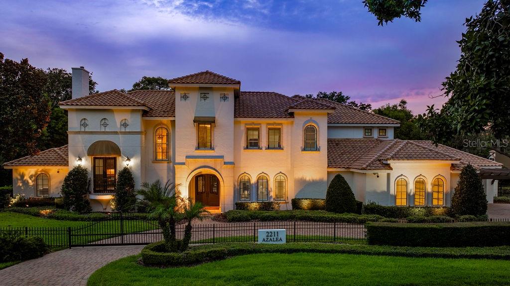 Exquisite Waterfront Estate in the Heart of Winter Park - Welcome to 2211 Azalea Place, a rare and remarkable waterfront estate nestled on a quiet street in one of Winter Park’s most prestigious neighborhoods—just moments from the exclusive Winter Park Racquet Club. This extraordinary residence offers the perfect blend of timeless architecture, refined finishes, and state-of-the-art updates, all set on almost 3/4 acre of beautifully landscaped canal-front lot with direct access to the coveted Lake Maitland and Winter Park Chain of Lakes.
Spanning an impressive 7,278 square feet, this two-story masterpiece rises 40 feet and is designed for both grand-scale entertaining and luxurious everyday living. Upon entry, you're greeted by soaring ceilings and elegant architectural details that set the tone for the home’s sophisticated style. With five expansive bedrooms—all featuring en-suite bathrooms—and six full baths plus a powder room, the home offers both comfort and privacy for family and guests. Two bedroom suites are located on the main level, ideal for multigenerational living or hosting overnight visitors, while the upper level includes three additional bedroom suites, a fully equipped theater room, a study room and a spacious game or playroom.
The heart of the home is the gourmet kitchen, where solid wood cabinetry, rich granite countertops, and Viking appliances come together to create a true culinary haven. The adjacent family room features one of the home’s three fireplaces and invites cozy gatherings or relaxed evenings overlooking the lush outdoor living space. The formal living and dining areas are equally impressive, offering elegant backdrops for holiday celebrations or intimate dinner parties.
Step outside to discover a true private oasis. The resort-style backyard boasts a saltwater heated pool and spa with all-new equipment, a summer kitchen, and a dedicated pool bathroom—perfect for effortless indoor-outdoor living. The entire property is fenced with newly installed gates, ensuring both privacy and security. From the manicured landscaping to the serene waterfront setting, every detail has been thoughtfully curated to elevate the experience of lakeside living.
For boating enthusiasts, the property includes a private boathouse, a dock with an automatic lift, and a 2 jetski dock—all providing seamless access to Lake Maitland and the entire Winter Park Chain of Lakes. Whether you're setting off for an early morning paddle, an afternoon on the water, or simply enjoying the sunset from your dock, this home offers an unrivaled connection to the natural beauty.
Additional features include a 5-car garage, 2 laundry rooms, dual staircases, all-new AC units, a comprehensive security system, and three wood-burning fireplaces that add charm and warmth throughout the home. Every inch of this residence has been impeccably maintained and thoughtfully updated, offering peace of mind and modern convenience without sacrificing its classic elegance.
2211 Azalea Place is more than just a home—it’s a lifestyle. This is a rare opportunity to own a one-of-a-kind estate in one of Winter Park’s most sought-after locations, where quiet sophistication meets waterfront luxury.
