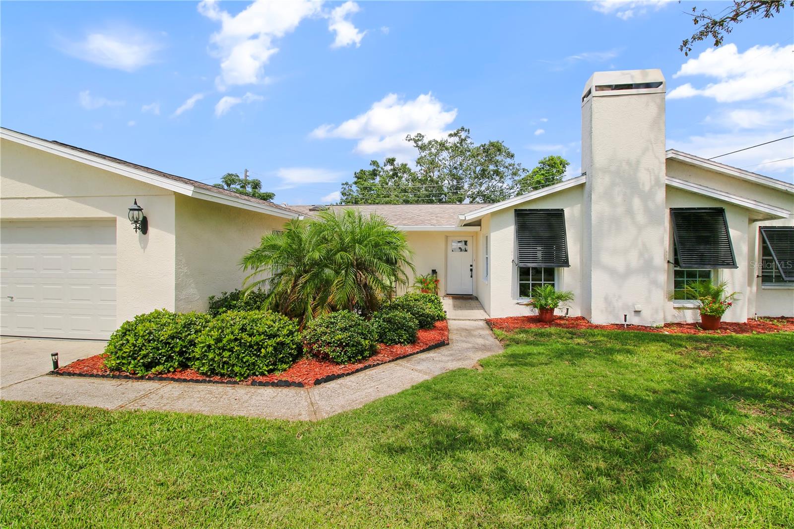 Beautiful 4/3 Home - Spacious and flexible - walk or ride to beaches and schools and Seminole City Center! Welcoming Front Patio! Updated Open Kitchen with Great Cabinet Space and Coffee Bar. Light and Bright Living Area. Huge Great Room with Wood Burning Fireplace. 4 Large Bedrooms. 3 Full and Updated Bathrooms. Double Door entry to Large Primary with EnSuite Bath and Custom Walk-in Closet. Plus Access to Patio and Landscaped Backyard. 2 Bedrooms share an updated Hall Bathroom with Jacuzzi Tub. 1 Large Bedroom and Full Bath off sep hall from Kitchen could be inlaw suite, guest apartment, teen suite, etc as it has a separate outside entrance access. Separate additional smaller room suitable for Office, Nursery, Playroom off the Great Room. Features: Newer Roof (2021). Updated Electric Panel. Newer Water Softener (2 yrs). Backyard with updated palm and shells landscaping. Bahamian Storm Shutters grace the Front of the Home for Safety and Beauty. Oversized 2 car garage with closet storage area and garage fridge. Inside Laundry Room with Washer and Dryer and access to Garage and Side Yard.