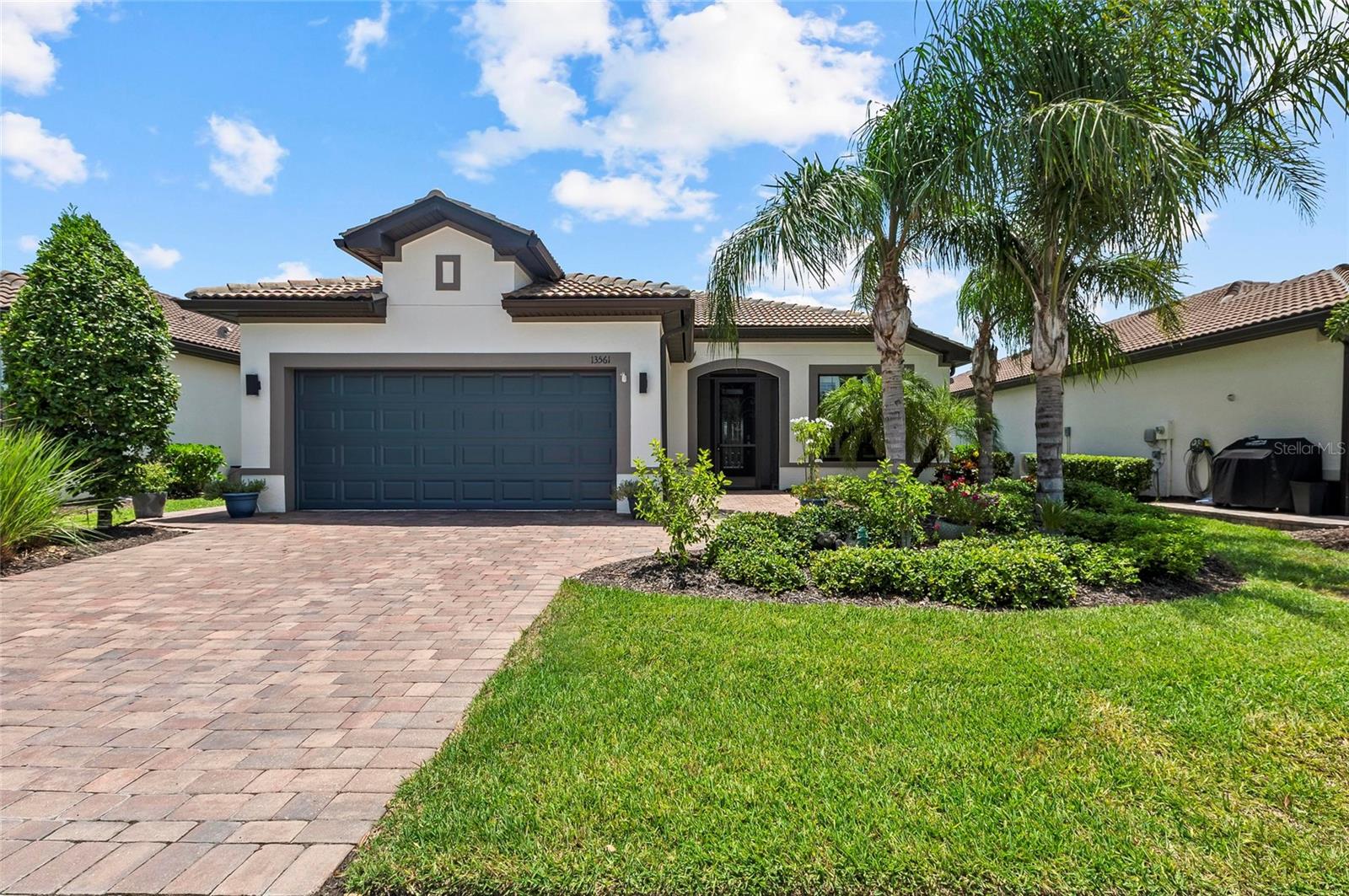 Stunning Martin Ray Model with Upgrades Galore & WATERFRONT Views! Welcome to this impeccably maintained and highly sought-after MARTIN RAY model, offering luxury, functionality, and style at every turn. This beautifully updated THREE BEDROOM PLUS DEN, 2-bath home is move-in ready with fresh paint (EXTERIOR JUST PAINTED), an extended paver driveway and walkway, and a screened-in front entrance that sets the tone for the elegance within. Inside, you'll find tile flooring throughout the main living areas, NEW LUXURY VINYL PLANK FLOORING in bedrooms, 8-foot doors, crown molding, higher baseboards, and upgraded woodwork in the hallway—all contributing to a polished, upscale aesthetic. The front den/office features glass French doors, perfect for working from home or relaxing in peace. The chef's kitchen is a true showstopper, complete with quartz countertops, custom backsplash, 42" upper cabinets, a butler’s pantry and stainless-steel appliances. The spacious great room opens through sliding glass pocket doors to a southern-facing lanai with SPF shades, a fully equipped OUTDOOR KITCHEN, and a HEATED SALTWATER POOL—perfect for year-round enjoyment. As you enter home from the garage- enjoy the convenience of a custom built in drop zone to hang your items! Newer IMPACT WINDOWS throughout the home provide peace of mind and energy efficiency, while plantation shutters add a timeless touch. The oversized garage boasts a 4-FOOT EXTENSION, epoxy floors, and ample storage space. The laundry room features a newer washer and dryer along with built-in cabinetry for added convenience. Retreat to the spacious primary suite showcasing serene water views, a luxurious bathroom with dual sinks, a frameless glass shower with tile inlay, and an oversized walk-in closet complete with custom built ins. This home combines elegant design, smart upgrades, and outdoor luxury—an exceptional opportunity to own one of the most desirable floor plans in the area. Don’t miss your chance to tour this gorgeous home today! IslandWalk is one of VENICE'S most social communities with a FULL TIME ACTIVITIES DIRECTOR, countless events and clubs and activities, TWO community clubhouses, an EVENT center, TWO resort style pools, a LAP pool, 12 PICKLE BALL Courts, 8 Har Tru Tennis Courts, DOG PARK, Playground, Basketball Court, Community Garden- the list goes on! The entire community is surrounded by miles and miles of golf cart trails, walking and biking trails, VENETIAN bridges and water! The Atlanta Braves Stadium is a short bike ride away- enjoy year- round events and activities. The new marketplace is now complete with PUBLIX, restaurants, shopping, gas station, etc! Downtown Wellen Park features an 80-acre lake, retail shops, restaurant waterfront dining and rooftop decks, pedestrian-friendly streets, a splash pad, a playground and a public town hall gathering place that hosts live theater and music events. Coming soon to downtown Wellen Park- a hammock grove and a permanent food truck area. IslandWalk HOA includes grounds maintenance, CABLE, WIFI, amenities, and 24-hour guard.