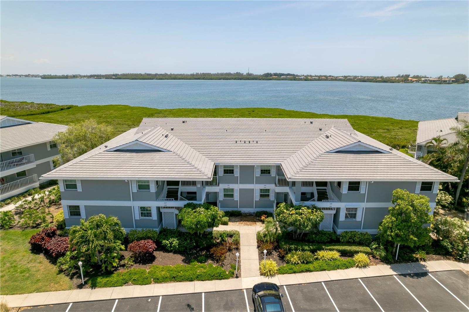 PERICO BAY CLUB – CONDO-BRADENTON- OWNER FINANCING AVAILABLE- Beautiful, turnkey, fully furnished 2 bedroom, 2 bathroom
first-floor condo with breathtaking views of Palma Sola Bay and the intercoastal waterways. Nestled in the well-established gated
community of Perico Bay Club, this condo combines luxury, comfort and convenience. Updated kitchen featuring custom "praline"
solid maple cabinets, stainless steel appliances, quartz countertops, soft-close drawers all complemented by luxury vinyl flooring. The
generous owner's suite boast picture-perfect waterfront views, a spacious walk-in closet, and an updated ensuite with dual vanities, a
seamless enclosed shower, and a heated towel rack. The condo also benefits with fresh paint, a new roof with retrofit 3rd nail
enhancing both insurance savings and providing extra wind and storm protection. Perico Bay Club offers an array of resort-style
amenities throughout this expansive community for you to be able to enjoy an active Florida lifestyle, including each neighborhood
having their own pool, a Clubhouse with an Olympic-sized pool, tennis and pickleball courts, shuffleboard, a fitness center, a library,
kayak launch, pier, new boardwalk and much more not to mention a full social calendar full of activities and events. Located just 2
miles from Anna Maria Island and a short bike ride to Robinson and Neal Reserve, this condo is perfectly situated for those who love
both relaxation and adventure. Don’t miss this opportunity to own a slice of paradise!