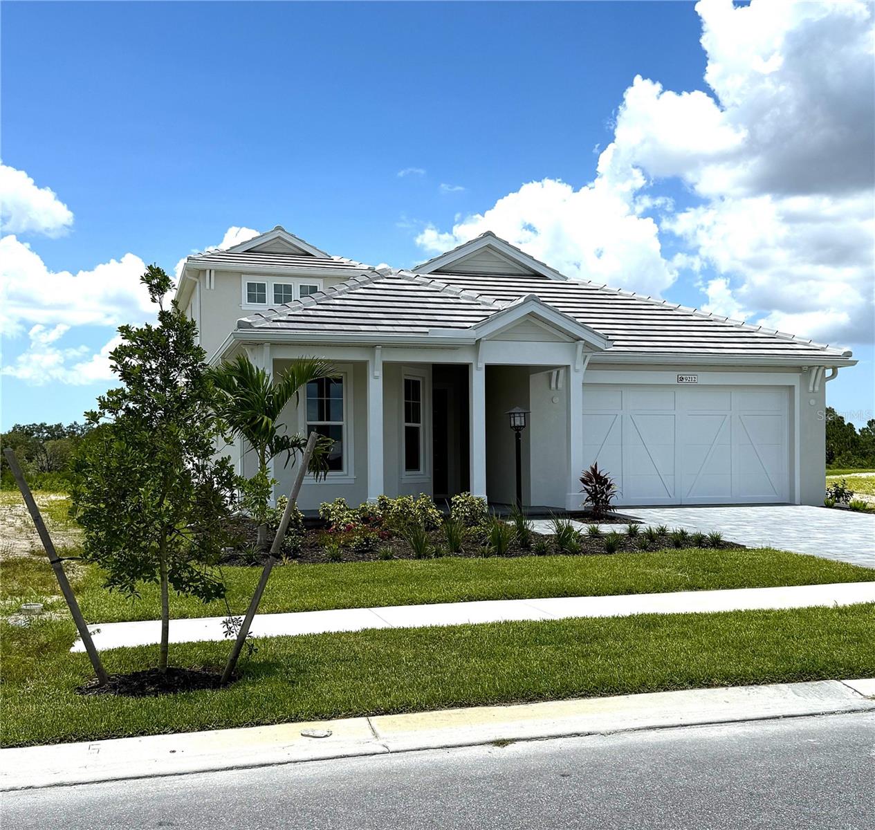 The Genoa offers 2,538 square feet with 3 bedrooms, 3 bathrooms, a den, bonus room, and a 3-car tandem garage with garage right orientation. Coastal elevation is featured along with tray ceilings in the foyer, den, great room, owner's suite, good morning room, and bonus room. The home includes upgraded kitchen cabinets, a gourmet kitchen with GE appliances, upgraded quartz countertops in the kitchen and bathrooms, and an upgraded kitchen sink. Below kitchen cabinet LED lighting is installed along with an upgraded tile package in the kitchen, baths 2 and 3, mudroom, laundry, dinette, great room, owner's suite, owner's walk-in closet, den, and suite 2. A frameless glass shower enclosure with a pivot door is included in bathroom 2, and upgraded bathroom cabinets are provided. The home features upgraded Moen plumbing fixtures, upgraded electrical and lighting packages, and additional lighting throughout. The great room opens to a large lanai and includes a half wall with rough-in for a future summer kitchen. Impact-rated windows and sliding glass doors are included, and the great room has a modified custom layout with a 16’ impact sliding glass door. The home is located within Shellstone at Waterside with access to The Summit at Shellstone Amenity Center offering a social hall, fitness center, pool and spa, firepit, poolside cabanas, poolside BBQ grills, and a fitness lawn. Nearby Midway Park Shared Amenity offers a pro shop, screened pavilion, play areas, dog parks, basketball court, 8 pickleball courts, 6 tennis courts, kayak launch, outdoor fitness, shaded picnic areas, and community walking and biking trails. The community is convenient to Downtown Waterside Place, Gulf Coast beaches, dining and shopping, hospitals, the Sarasota School System, Sarasota International Airport, and Tampa International Airport.