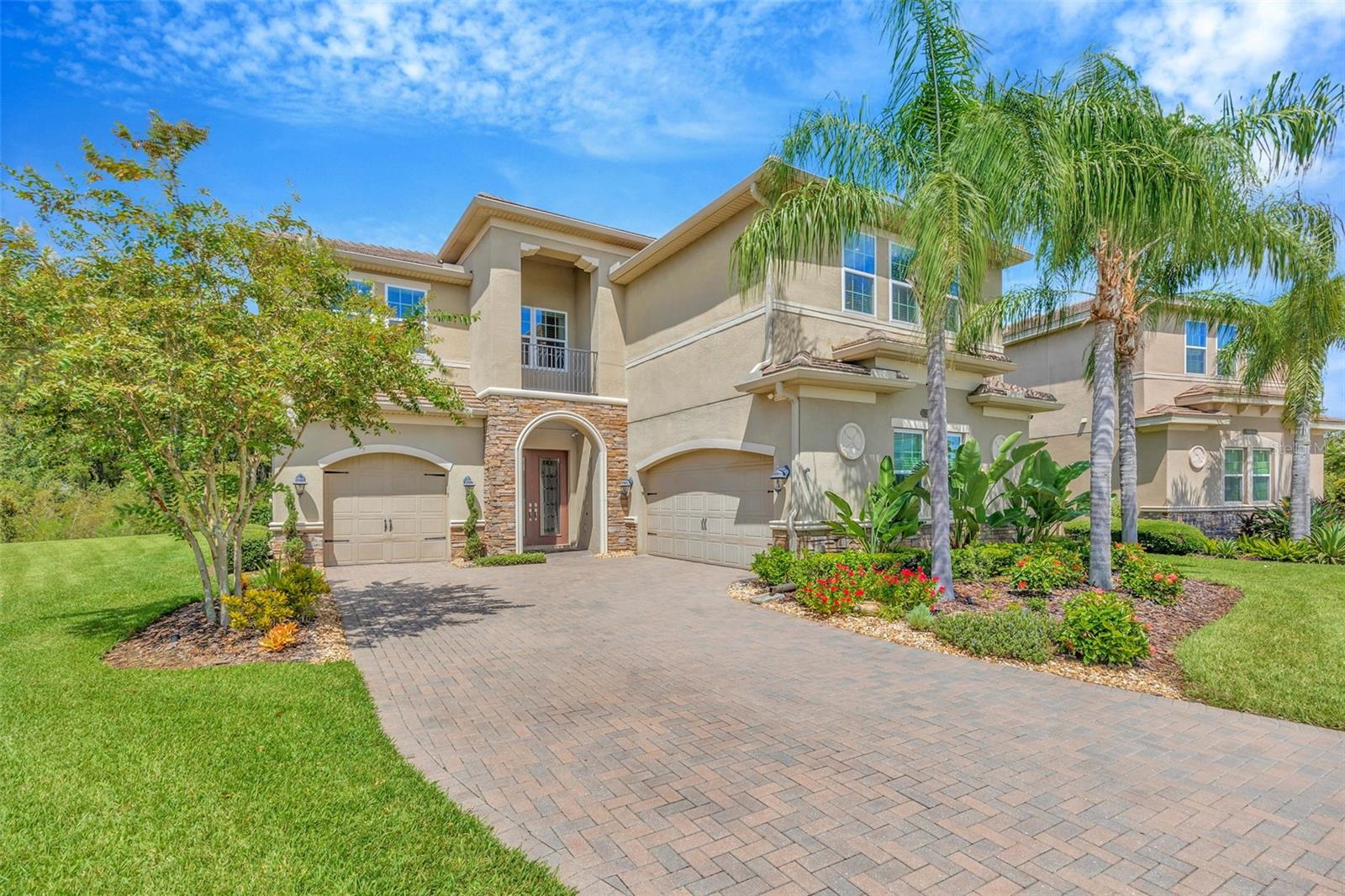 Absolutely STUNNING pool home with over 4000sf of living space featuring 5 Bedrooms, Media Room w wet bar and split 3-Car Garage situated on a gorgeous preserve lot at the end of the cul de sac. This is luxury living in The Ridge at Wiregrass Ranch, the premier community in the heart of Wesley Chapel. As you enter the home you see the soaring 2-story foyer and living room with views of the expansive preserve giving you a sense of tranquility. The gourmet kitchen features stacked upper cabinets with crown molding, a center island with breakfast bar, custom tile backsplash, natural gas cooktop, stainless steel range hood, and new Samsung stainless steel refrigerator and LOADS of counter space for cooking or entertaining. The kitchen is open to family room so you feel part of the action! The family room is spacious enough for your sectional sofa and features a trayed ceiling with crown molding and lots of light for entertaining. There’s a ½ bath just off the family room and lanai that’s a custom addition to this home! No tracking wet bathing suits through the house. French doors lead onto the travertine tiled lanai where you can relax by the pool or soak in the hot tub and enjoy the views of the preserve through the PANORAMIC SCREENING. There’s even a sun deck in the pool to park your lounge chair and soak your feet. The lanai also has a natural gas connection if you want to install an outdoor kitchen after you move in. Inside, the PRIMARY Suite is located on the main floor and features dual walk-in closets w built-in shelving, trayed ceilings and a luxurious en-suite bath with garden tub, separate shower with bench, separate his/hers vanities with granite counters and undermount sinks. The remaining bedrooms and Media Room are located upstairs. The 5th Bedroom/den is downstairs along with a full bath - The perfect guest suite! Upstairs, each of the 3 secondary bedrooms has a ceiling fan and walk-in closet with built-in shelving. The Media Room is large enough for Game or Movie Night and features a wet bar with beverage/wine refrigerator. The home has been fitted with IMPACT RESISTANT WINDOWS and there’s even a Hurricane Shield for the front door for added protection. Additional features include a separate outlet for EV charging, Tankless Natural Gas Water Heater, NEW AC (upstairs and downstairs 2025), water softener, and separate natural gas line for a generator (approved by the HOA, but never installed), new tile and carpet throughout the home and freshly painted interior. The Ridge is a luxury community in Wesley Chapel centrally located on SR 56. Amenities at The Ridge include an 11,500 sf indoor clubhouse located on 5.5-acres. The clubhouse features an event room, an indoor sports complex, game room, movie theatre, fitness center, and kitchen. Outdoors boasts 4 lighted Hartru clay tennis courts, basketball, sand volleyball, resort pool with beach entry, lap pool, fire pit, and water play area. The community is minutes from the Shoppes at Wiregrass, Tampa Premium Outlets, 3 local hospitals, restaurants and Top-Rated Area Schools. Call today for your opportunity to view this home!