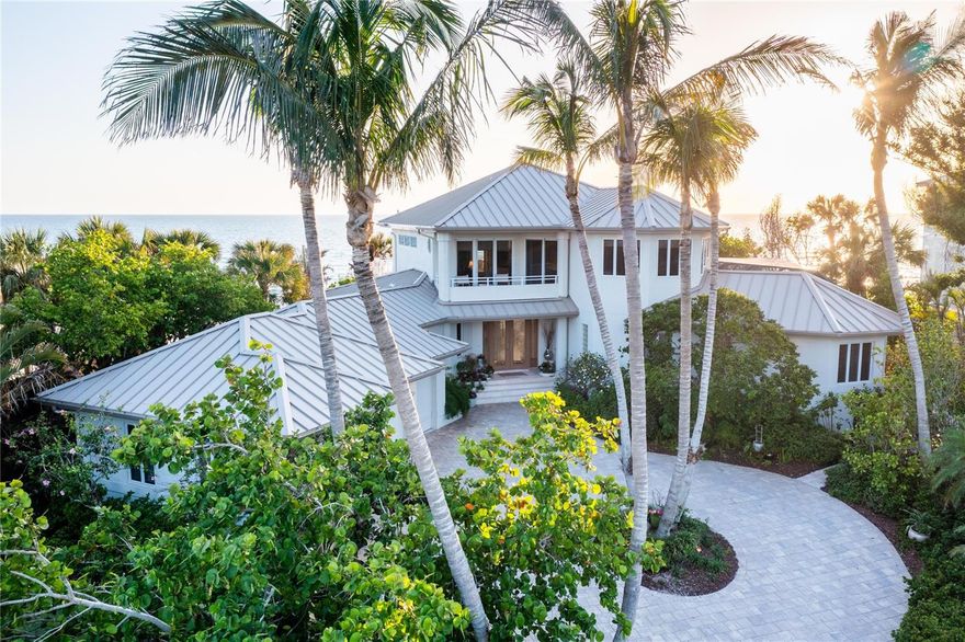 Under contract-accepting backup offers. Welcome to your own private coastal retreat—where your backyard is the beach and every day feels like a getaway. This rare, direct beachfront estate on North Manasota Key delivers the ultimate in tranquility, seclusion, and barefoot luxury on one of Florida’s most coveted barrier islands.

Tucked within an exclusive, gated community of fewer than 80 homes along a serene two-mile private road, this property offers a lifestyle defined by natural beauty and relaxed elegance. With approximately 135 feet of pristine Gulf frontage and 147 feet on the Bay, all set on more than an acre of land, this elevated haven (rising 15 feet) captures the essence of true coastal living. NO DAMAGE OR WATER INTRUSION IN THE HOUSE FROM HURRICANE HELENE OR MILTON!

Step inside to 4,533 square feet of sun-drenched interiors where panoramic water views steal the show. An open-concept layout connects the main living spaces, perfectly designed for hosting and relaxing—whether you’re gathering around the dining table or savoring morning coffee with nothing but sea and sky in view.

The chef’s kitchen features generous cabinetry, new Dolomite countertops, ample storage, and windows that frame both the Gulf and the pool, blending indoor comfort with natural inspiration. Just outside, the shell-stone lanai is your private oasis: a heated pool and spa surrounded by lush native gardens, a built-in Wolf grill, skylights for natural light, and a pool bath for added convenience—all just steps from the sand.

The home’s thoughtful layout provides separation and privacy for family and guests. Two ensuite bedrooms on the ground floor are positioned in their own wings, while a flexible third ensuite—currently used as a den—can easily become a fourth bedroom, also having a large storage closet and beautiful Gulf views. Upstairs, the spacious master suite is a peaceful retreat with stunning beach and bay views, with a two-sided fireplace, sitting area, spa-like bath, and a private Brazilian walnut wood deck overlooking the Gulf. A second covered balcony on the bay side and a refined office with custom built-ins round out the upper level.

Meandering stone paths wind through lush, newly landscaped grounds adorned with vibrant orchids and native palms, guiding you to a brand new beach walk-out and your own secluded stretch of sand. A thoughtfully engineered sand berm provides vital protection against beach erosion, offering peace of mind and preserving your pristine shoreline for years to come. Along the way, discover multiple shaded and open-air sitting areas—perfect for morning coffee, sunset views, or simply soaking in the serenity of this coastal haven. Here, you can stroll the shoreline in search of seashells and shark’s teeth, watch dolphins play at sunset, or simply unwind with your toes in the sand. On the bay side, your recently resurfaced private dock (2024) and upgraded 10,000 lb boat lift (2023) offer endless opportunities for boating, fishing, or paddleboarding.

Though it feels a world away, you're just minutes from golf, tennis, dining, boutique shopping, and top-rated schools.

This is more than a home—it’s a beachfront sanctuary, where life slows down and every day feels like a vacation.