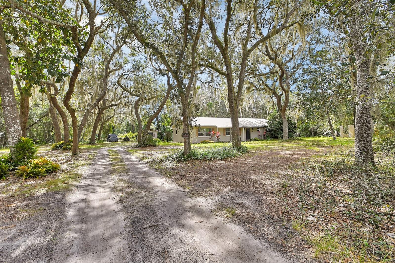 Check out this 3 bedroom 3 bathroom, block home on almost an acre of land with beautiful live oaks and in a private, secluded neighborhood! This home has a metal roof, new septic system and has completely renovated inside and out within the last 5 years! The kitchen offers shaker style cabinets with quartz countertops, stainless steel appliances and a large farm style sink! The home has a split plan offering a formal master suite with a walk-in shower and large bathroom! The guest bedrooms are both good size with one bedroom having a full bathroom to it itself! The LVP flooring ran though-out the house is seamless along with tile in the bathrooms. There is also a full inside laundry with pantry space and room for more storage! On the exterior you will find a cute covered front porch, and a large open back lanai for any of your entertaining needs! Come check this place out!