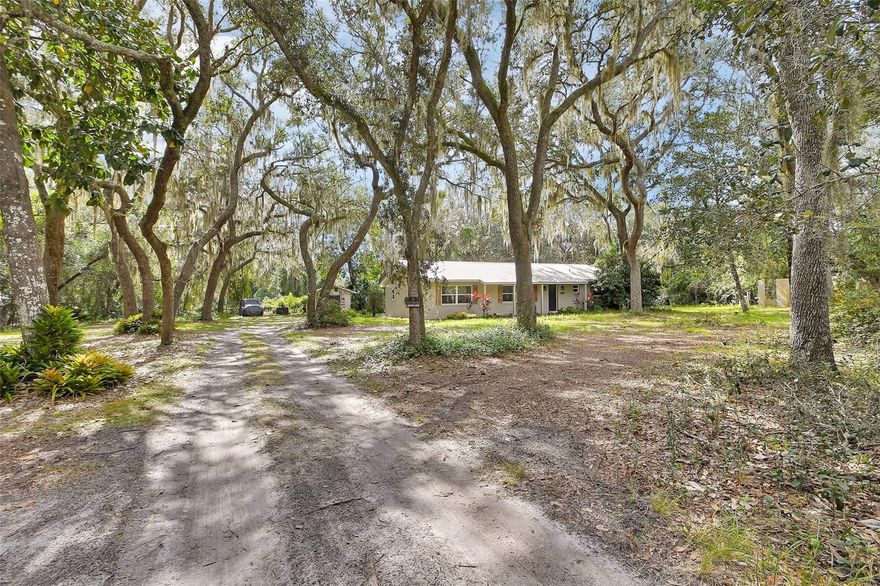 Check out this 3 bedroom 3 bathroom, block home on almost an acre of land with beautiful live oaks and in a private, secluded neighborhood! This home has a metal roof, new septic system and has completely renovated inside and out within the last 5 years!  The kitchen offers shaker style cabinets with quartz countertops, stainless steel appliances and a large farm style sink!  The home has a split plan offering a formal master suite with a walk-in shower and large bathroom!  The guest bedrooms are both good size with one bedroom having a full bathroom to it itself!  The LVP flooring ran though-out the house is seamless along with tile in the bathrooms.  There is also a full inside laundry with pantry space and room for more storage!  On the exterior you will find a cute covered front porch, and a large open back lanai for any of your entertaining needs! Come check this place out!