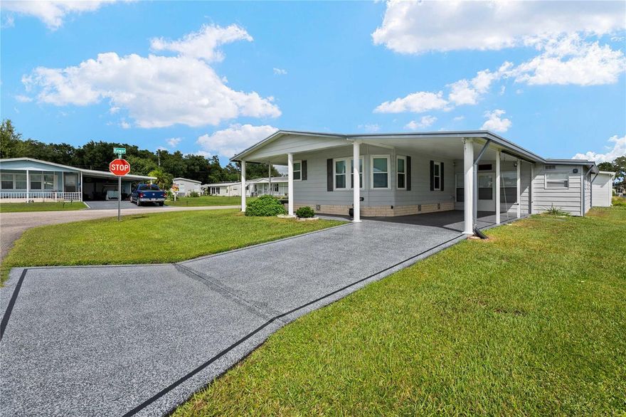 Welcome to Betmar Acres, an active 55+ golf community where you OWN the land for just $435 a year! This beautifully updated 2BR/2BA home sits on a desirable corner lot and offers 1,540 sq. ft. of meticulously maintained living space. From the moment you arrive, the curb appeal sets the tone for the care and attention that shines throughout. Step inside to a spacious living room enhanced by stunning luxury vinyl plank flooring (2018), which flows seamlessly through the home. The open dining area, complete with a built-in China cabinet, connects effortlessly to the eat-in kitchen, a true chef’s delight with solid wood cabinets, granite countertops, and newer Whirlpool appliances. A wide hallway—ideal as an office or workspace—leads to the expansive Owner’s Retreat. This private suite features two walk-in closets, ceiling fan, and a spa-like ensuite bath with step-in shower, granite-topped vanity, linen storage, and even a make-up vanity for your morning routine. The guest suite is equally inviting, comfortably fitting a queen-size bed, with its own walk-in closet and ceiling fan. The guest bath, updated in 2019, boasts a granite vanity and step-in shower. Additional highlights include an inside laundry room with built-in storage and an inviting four-season Florida room, enhanced by a mini-split system (2020) for year-round comfort. Perfect for entertaining, relaxing, or welcoming overnight guests, this space opens to a versatile workshop/storage area with auto roll-up door—ideal for your golf cart. This home is move-in ready with extensive updates: Metal roof (2018) TPO membrane roof over Florida room (2023) New insulated roof over carport & lanai (2019) Double-pane windows (2018) New ductwork with HVAC (2018) Hot water tank (2019) Exterior paint (2018) & driveway paint (2022) Updated lighting (2018 Five additional tie-downs for peace of mind Life in Betmar Acres is all about enjoying the Florida lifestyle. Tee off on 27 holes of golf, swim in one of the two heated pools, relax in the spas, or spend time at shuffleboard, billiards, mini golf, or the new library. With endless activities and friendly neighbors, this is more than a home—it’s a lifestyle. Pack your bags and schedule your tour today—this corner-lot gem won’t last!
