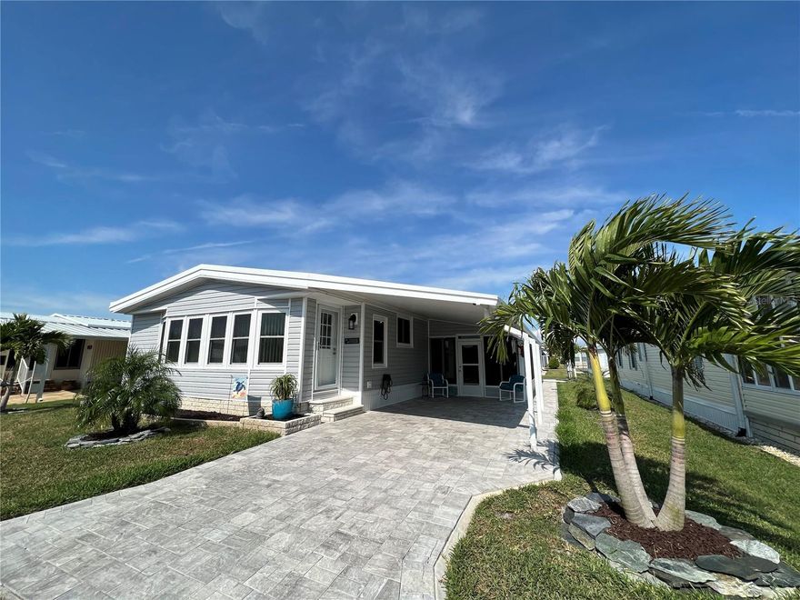 Welcome home! This beautiful home is loaded with updates. 2 bed 2 bath with an additional cooled all seasons room. Newer vinyl siding, skirting and drainage lines for down spouts. Newer roof overlay, widened with extension posts in carport. Updated landscaping with new sod and palm trees. Double hung windows. Upgraded electrical panel,  hot water heater and hvac unit. Newer floors and newer drywall. Updated electrical outlets and switches. Fully updated kitchen with countertops and cabinets. Master has a huge walk in closet!