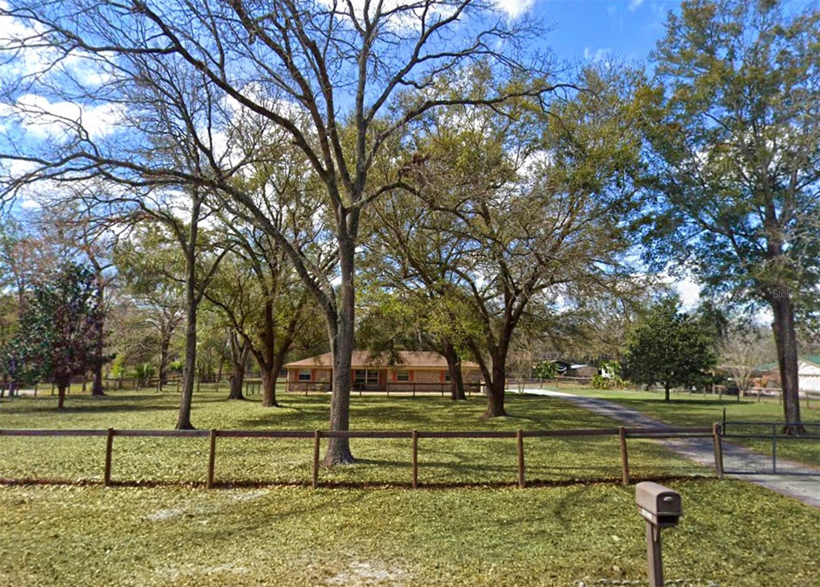 BRING YOUR HORSES! Room for your RV, Boat, Motorcycles, and MORE! Warm and Tranquil Comforts are Calling! This all brick 4 bed, 2 bath Ranch Pool Home on 2.6 acres in sought after Foxmeadow Equestrian Estates offers just the right balance of comfort and practicality. Gorgeous Olde Florida property with picturesque oaks, cross fenced pastures, power access gate with keypad and remote features. Property backs up to Jennings State Forest trails. Best of all, No HOA!! NEW ROOF and WH (full ask). New Pool liner and New Pool pump motor, Multiple Outbuildings including a 20x24 stable with two 12x12 stalls on slab with stall mats, power, water, and fan. Divided 24x24. barn/workshop/garage on slab with a finished cooled tack storage room. Separate open wash bay on slab. Store your toys, equipment, and more in the detached mechanical shed. New air handler with upgraded filtration. Septic System, and grey water tank. Two wells and a superior water softening/purification system. Huge 25x24 Florida Room with Removable Vinyl Windows. Freestanding wood burning fireplace adds charm and function! Original hardwood cabinets and parquet flooring. The spacious primary bedroom featuring an en-suite with step in shower. Storage, Storage, Storage, and full a laundry room with direct yard and garage access. Updated Alumiconn outlets 2020. If you're seeking a home that provides privacy, space, and endless potential, this beautiful property is for you! Foxmeadow offers the perfect blend of rural charm and suburban conveniences. Residents enjoy neighborhood proximity to newly updated Orlin P. Payne Foxmeadow Park and its LifeTrail fitness path, pickle ball and basketball courts, sports fields, a picnic pavilion, and a children's playground. Plus exclusive access to the community equine training arena. Live the Country Life, just minutes to Every Convenience. Foxmeadow is just minutes from shopping, dining, and other essential services. Only 35 mins to downtown Jax via swift access to First Coast Expy FL-23. Only 45 mins to Jacksonville International Airport. THIS unique combination of features is truly rare. Seller is downsizing in preparation for retirement. Schedule a private showing TODAY!