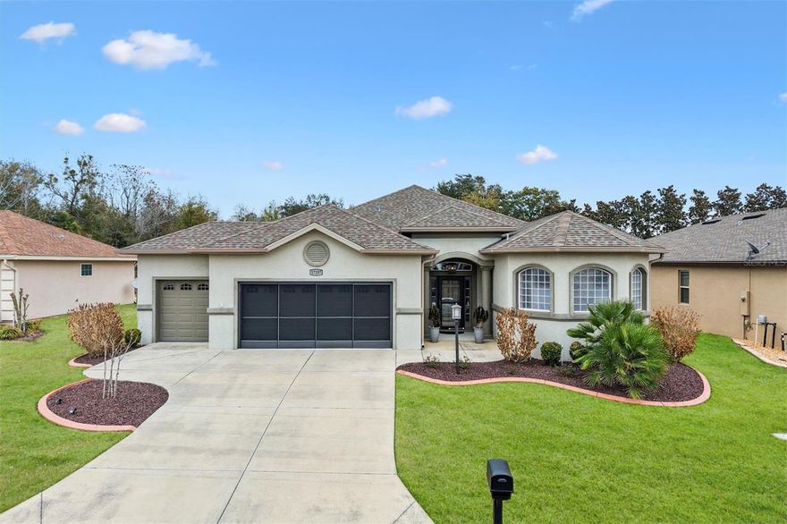 Located in the Exclusive 55+ Gated Golf Community of STONECREST, adjacent to THE VILLAGES, Fl, this beautifully maintained CONCRETE/BLOCK/STUCCO Maple Floor plan offers the lifestyle you’ve worked so hard to enjoy. From the moment you arrive, the low-maintenance landscaping and strong curb appeal set the tone for easy Florida living.  Inside, the home showcases 10 Foot ceilings, elegant CROWN molding, and PORCELAIN PLANK TILE Flooring throughout, no carpet to maintain. The open split-bedroom layout provides both connection and privacy, with a pocket door that allows guests to enjoy their own private suite. The spacious Primary ensuite is truly exceptional, Featuring 3 WALK-IN closets and a custom WALK-THROUGH Tiled shower designed for both comfort and style.  The Kitchen is thoughtfully appointed with QUARTZ countertops, Stainless Steel Appliances, custom Cabinetry, and a VENTED-to-EXTERIOR RANGE HOOD, making it as functional as it is beautiful. Just beyond the main living area, the ENCLOSED LANAI with GLASS Windows, French doors, and Custom Shades offers a perfect year round retreat for morning coffee or evening relaxation.  Additional upgrades include a  WHOLE HOUSE WATER FILTRATION SYSTEM, WHOLE HOUSE SURGE PROTECTOR, and INSTALLED GUTTERS and DOWNSPOUTS. The 2 Car Garage plus GOLF CART GARAGE with Sliding Screens gives you all the storage and flexibility you need.  The backyard offers PRIVACY with NO rear neighbors, creating a serene outdoor setting! Life in Stonecrest means enjoying four pools, including an indoor saltwater pool, along with pickleball courts, softball, shuffleboard, a fitness center, library, community center, on-site restaurant, and golf. With countless clubs, activities, and entertainment options, boredom simply isn’t part of the lifestyle.   Easy access by golf cart to shopping, dining, medical facilities, and nightly entertainment.  This is more than just a home, it’s an opportunity to step fully into the vibrant, active retirement you’ve been dreaming about. Schedule your private viewing today!