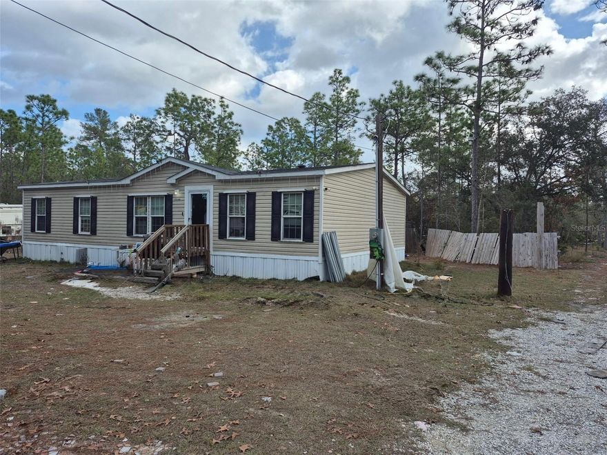 2022 manufactured home is nestled on a spacious 2.5-acre lot in Weeki Wachee, Florida – a hidden gem known for its crystal-clear springs, mermaid shows, and abundant outdoor adventures. Perfect for nature lovers, this property offers privacy and room to roam, with plenty of space for gardening, RV parking, or even adding outbuildings.