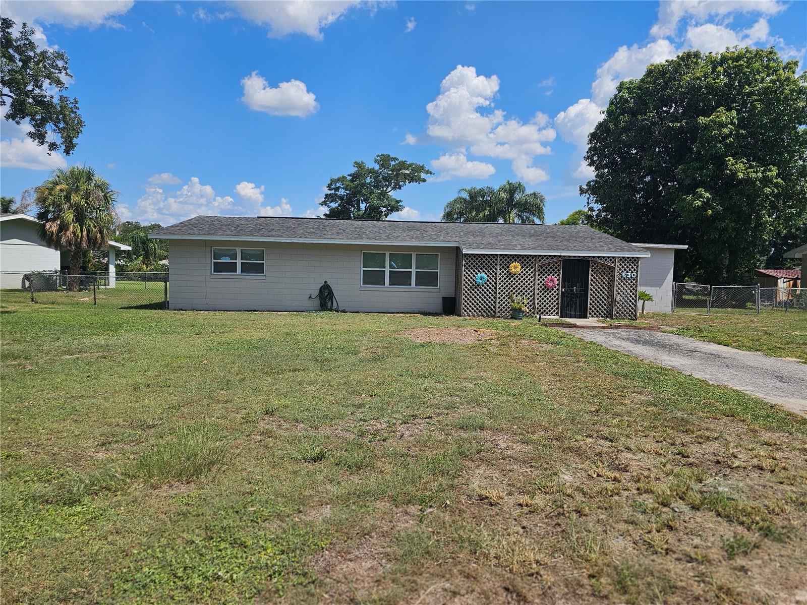 Step into the charm of small-town living with this freshly painted vintage concrete block home nestled on approximately ½ acre in an established neighborhood of Lake Placid—proudly known as “The Town of Murals” and “The Caladium Capital of the World.” This 2-bedroom, 2-bathroom home offers not just one, but two porches and two bonus areas, perfect for relaxing or customizing to fit your lifestyle. Whether you need a getaway home, a vacation pad, or a new place to call home, the possibilities are endless. Fully fenced for privacy, with room for a barn, pool, or toys, the spacious yard features a 22x12 shed on the patio. Conveniently located near Lake Blue and Lake Clay (public ramp), with easy access to US 27, this home offers a peaceful setting while still keeping you connected to major cities and both coasts. Roof 2018, AC 2015, Water heater 2020, and some windows replaced (double pane). Living in paradise can be more than a dream—make it your reality today!