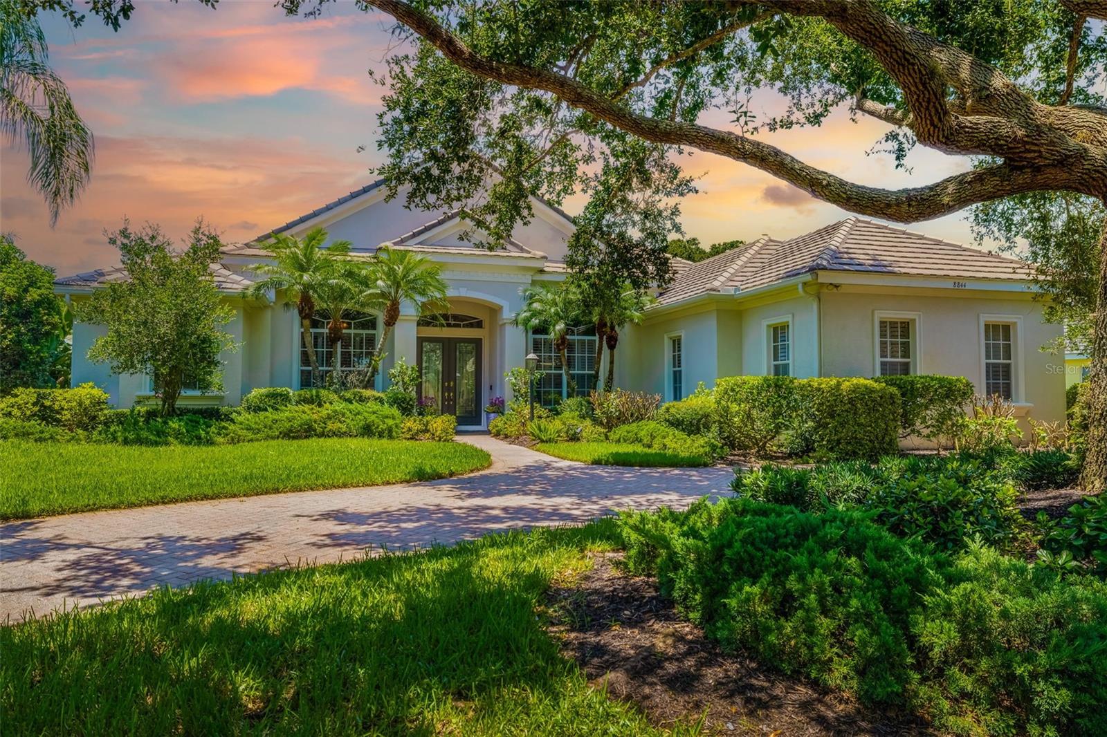Discover the pinnacle of luxury living in the prestigious Silver Oak gated community. This beautifully maintained residence features three spacious bedrooms, three-and-a-half baths, and two dedicated offices/den, all nestled on a beautifully landscaped lot adjacent to a serene nature preserve. As you step through the elegant double-entry front doors with leaded glass accents, you’ll be captivated by the exquisite details and premium finishes throughout. The living area impresses with 11-foot ceilings and expansive triple pocket sliding glass doors, inviting you to the oversized covered and screened lanai, which overlooks a stunning pool and spa. This outdoor space is designed for entertaining, offering multiple areas to enjoy Florida’s radiant sunshine. The well-appointed kitchen is a chef's dream, ideal for casual dining, featuring granite countertops, custom wood cabinets with crown molding, Double Oven, striking under-cabinet lighting, a breakfast bar, a gas cooktop, a central island, and a bright breakfast room with a built-in desk. The adjacent family room enhances the home's open concept, complete with a cozy gas fireplace framed in granite and zero-corner sliding doors that seamlessly connect the indoors to the outdoor living area. The primary suite provides a sanctuary of privacy, highlighted by a double-tray ceiling with crown molding, direct lanai access, and two walk-in closets. Its en-suite bath boasts a double vanity with marble countertops, a luxurious jetted soaking tub, and a walk-in tile shower. The thoughtfully designed split-plan layout ensures guests enjoy their own privacy, each with their own private bath. This residence also features two offices equipped with built-in desks and shelving, perfect for productivity. Additional amenities include a three-car garage, gas generator, Electric dog Fence, elegant trim accents, recessed ceiling speakers, 8-foot doors, plantation shutters, tinted windows, security system, and updated LED lighting. Conveniently re-piped in 2008 with CPVC and complemented by a Ring video doorbell and an extra refrigerator in the garage, this home caters to modern needs. Perfectly situated less than a mile from a new Publix shopping center and just minutes from a variety of shops, restaurants, the YMCA, Costco, Target, a movie theater, the Legacy bike trail, and Siesta Key Beach, this home offers an exceptional blend of luxury, privacy, and convenience. Experience the ultimate in Florida living at Silver Oak!