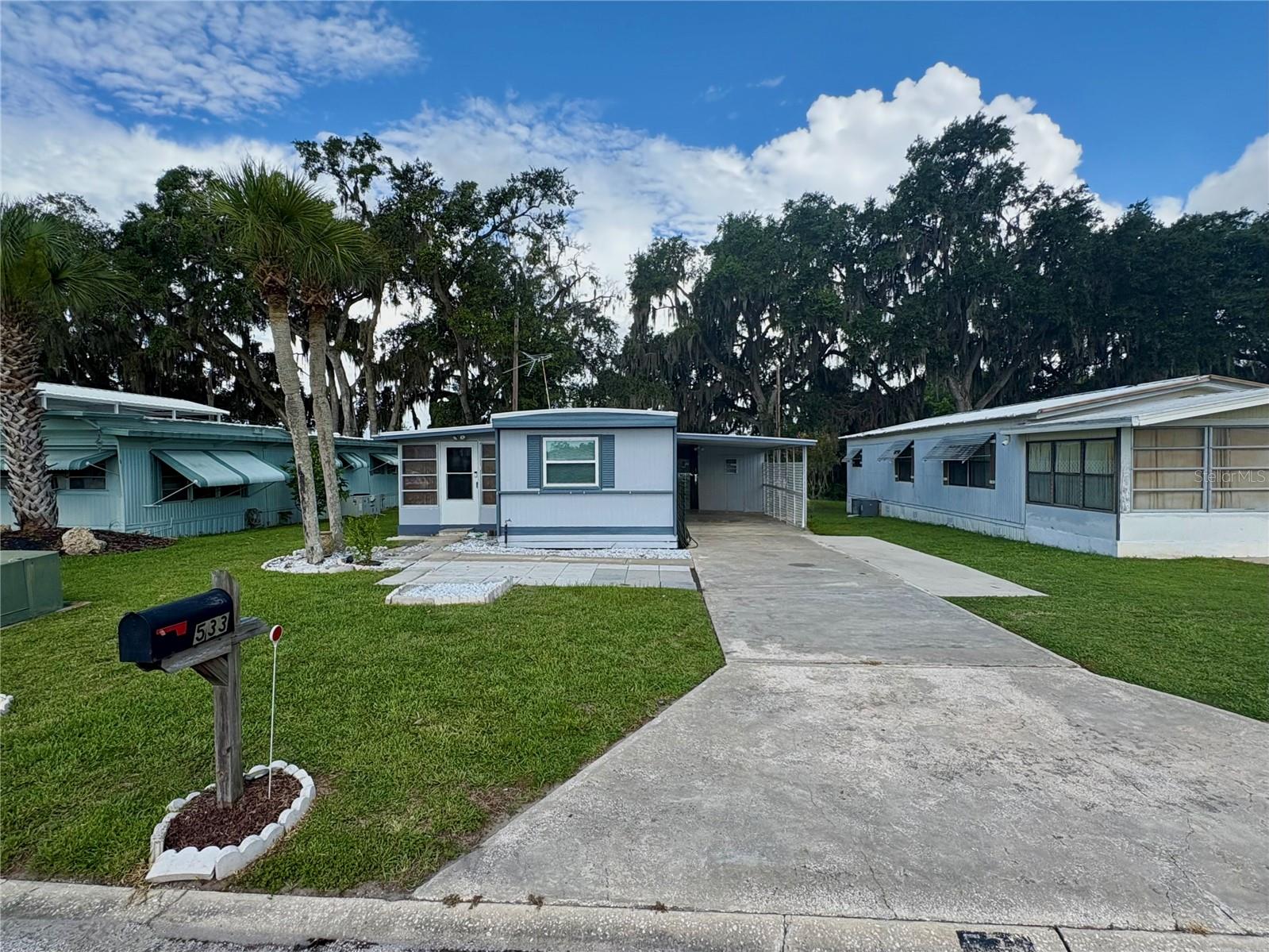 WOW! Updated Home – No HOA, No Lot Rent, and No Rear Neighbors! Welcome to this 3/2 beautifully updated and move-in-ready home offering comfort, privacy, and freedom with NO HOA and NO LOT RENT! Enjoy a spacious Bonus Room with A/C, perfect for relaxing year-round. The extended driveway and large back patio provide plenty of room for entertaining, hobbies, or just unwinding in your own space — and best of all, no back neighbor for added privacy with a fenced backyard and sided fenced area for your pets! Cut costs with the included TV antenna for free channels, and breathe easy with a special air filtration system installed in the A/C. Major upgrades completed in 2019 include the roof, A/C, energy-efficient double-pane windows, and new flooring!. You'll also love the oversized utility room with electric service — ideal for laundry, a workshop, or additional storage. Conveniently located just 7 minutes from Downtown Leesburg, near hospitals, shopping, dining, and the excitement of Leesburg Bike Week. Coachwood Colony community is close to The Villages as well. Don’t miss this rare opportunity — schedule your private showing today! FYI, 10x20 storage shed does not convey.
