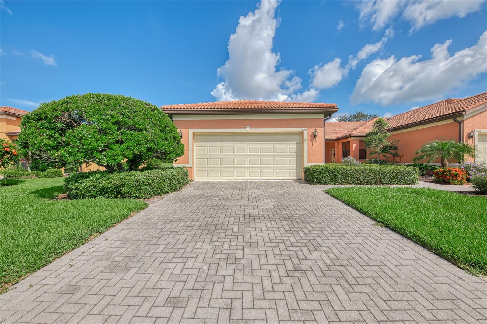 Discover resort-style living in the vibrant 55+ community of Venetian Falls with this stunning former model villa at 1350 Maseno Dr, Venice, FL. This meticulously maintained 2-bedroom, 2-bathroom end-unit villa, spanning 1,574 square feet, offers an open floor plan, modern upgrades, and an enviable lifestyle in one of Venice’s premier active adult communities.
Step inside to a bright and airy interior, featuring crown molding, a spacious combo living and dining room, and an open-concept layout perfect for entertaining. The gourmet kitchen shines with updated stainless steel appliances, sleek granite countertops, and ample cabinetry, ideal for culinary enthusiasts. The adjacent office/den provides a versatile space for work, hobbies, or relaxation.
The primary suite is a serene retreat with generous closet space and a luxurious en-suite bathroom, while the second bedroom and full bathroom provide comfort for guests or family. A separate laundry room adds convenience, and the extended lanai invites you to unwind with tranquil views of the lush surroundings—perfect for morning coffee or evening gatherings.
This end-unit villa boasts a 2-car garage with pedestrian door access, ensuring ease and ample storage. As a former model home, it exudes quality craftsmanship and thoughtful design details throughout.
Living in Venetian Falls means embracing an active, social lifestyle. Enjoy the resort-style pool, resistance pool, state-of-the-art workout facility with showers and lockers, bocce courts, and a putting area—all just steps from your door. Located in the heart of Venice, you’re minutes from pristine Gulf beaches, downtown shopping, dining, and cultural attractions.
Move-in ready and brimming with upgrades, this villa is your gateway to carefree, luxurious living in a vibrant 55+ community. Don’t miss this opportunity to call 1350 Maseno Dr home!