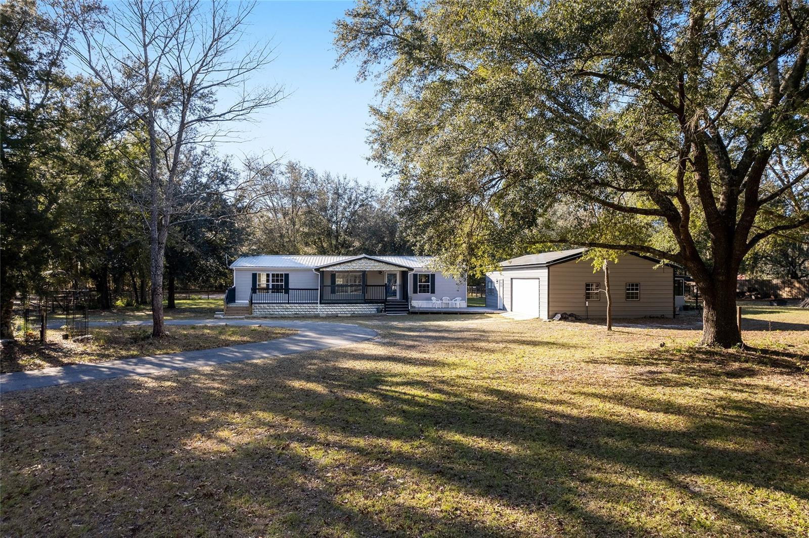 Nestled in Morriston short walking distance to the GOETHE Forest, this is a trail rider's dream location!!!! This exquisite 3-bedroom, 2-bathroom split-plan home sits on 4.5 acres of picturesque landscape, creating a haven for nature lovers and those seeking the tranquility of rural living. The home is completely remodeled with meticulous attention to detail. Luxury vinyl flooring and new appliances elevate the living experience. The kitchen features a wonderful breakfast bar with stone details and under-counter lighting. The dining area feature french doors looking out on to the beautiful backyard. The luxurious master bathroom boasts dual sinks and a stunning jacuzzi tub for ultimate relaxation. Porches in the front and back offer ideal spots to savor the beauty of the surrounding trees and wildlife. New metal roof, septic, and HVAC and a 50 amp RV hookup.
Minutes from the Goethe Forest, Black Prong, World Equestrian Center, HITs
The outdoor amenities include 5 paddocks with lean-tos for your equestrian companions. In addition, there are two 24 x 40 garages, both built within the last 4 years, each equipped with 100-amp electrical service. One garage features an oversized 2-car space and an amazing bar with a screened-in porch, providing a year-round venue to embrace Florida's delightful weather.
The property is designed for Energy-Efficient Living, including solar panels and battery back-up, significantly reducing electric bills, showcasing a commitment to sustainability.
The beautiful, gated entrance with a lighted 500 foot asphalt circular driveway welcomes you home. And for the remote workers, no worries, the AT&T Fiberoptic cable ensures high-speed internet, (AT&T Business trenched down the county road). The WIFI extends to the gate for added security to support a camera with 2-way sound and for monitoring/controlling the gate.
Easy access to the GOETHE Forest for nature enthusiasts, but there's plenty of nature here too, with raised bed gardens with amended organic soil, a greenhouse and orchards catering to gardeners. The extensive improvements on this property offer an extraordinary opportunity at a reasonable price, creating a perfect blend of modern comforts and natural serenity. This property is perfect for the equestrian, gardner, nature lover and just about everybody!This was owners retirement dream home so they made significant improvements but they found a family farm with larger acreage. Their loss buyers gain. Don't miss this chance to own a piece of paradise. Schedule a private tour and experience the unparalleled lifestyle this property affords.
Minutes from the Goethe Forest, Black Prong, World Equestrian Center, HITs