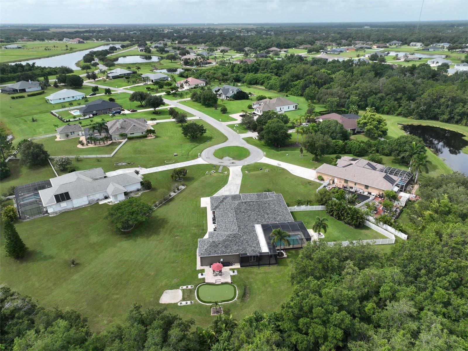 Situated on a beautiful 1-acre homesite at the end of the cul-de-sac with a preserve backdrop, this home is a golfer’s dream! The backyard boasts a professional 504-square-foot Signature Series 3-hole putting green complete with a sand golf bunker, perfect for practicing your short game. Spacious property offers incredible versatility including a main home with a split 3-bed, 2 bath floorplan, oversized 3-car garage, plus a thoughtfully designed in-law suite includes a full kitchen and more. **Be sure to explore the Matterport 360 virtual walkthrough to fully appreciate both living spaces** Upon entering the main home, you’re greeted by an open floor plan, double tray ceilings, and excellent sight lines. The main home boasts a living room/dining area, and the kitchen family room area also includes a breakfast nook. The primary bedroom suite features two large walk-in closets, an ensuite bathroom with a soaking tub and walk-in shower, and convenient access to the pool and spa area. Both the main home and the ADU feature seamless ceramic tile flooring; you can breathe easier knowing the roof is only 3 years old and newer appliances throughout both living spaces. (Ask agent for the Features & Upgrade handout) In 2018, an in-law suite/ADU was designed by Wolfe Architecture with ADA-friendly doorways & shower; it was brought to life by McKenzie Homes. Designed with both aesthetics & durability in mind, it features impact windows/doors, and extra soundproofing ensures a peaceful living environment between the main home & ADU. Enter the ADU and find a great room open floor plan, you’ll notice the full kitchen’s modern touches. The kitchen & bath feature all-wood Polar White cabinets with granite countertops. The spacious kitchen island provides ample room for eating & meal prep, complemented by deep cabinet drawers & tall pantry cabinets with pull-out shelves. High-end LG appliances including convection range, microwave, refrigerator & dishwasher,add to the kitchen's modern appeal. The primary ADU bedroom alone is 14x17 feet which does not include the walk-in closet or ensuite with walk-in shower adorned with dual shower heads, built-in shelves, grab bars for security, and safety/convenience seating. Call it what you want: guest home, multi-generation living, in-law suite, or ADU, it’s still the same beautiful space! The ADU also has access to the main home’s living area via an interior door enhancing usability of the space. Also in 2018 a stunning outdoor oasis was crafted featuring a large 14x28 ft saltwater pool with a sun shelf & heated spa, all easily controlled with a wireless remote. The pool area is enclosed by a stylish pool cage providing both safety & comfort; a built-in outdoor kitchen was added, perfect for entertaining. This culinary delight includes a Blaze grill & griddle, a Komodo Joe Red Egg grill & an outdoor refrigerator to keep your tasty treats and cold beverages conveniently close. Over the years exterior lighting & landscaping were added to enhance ambiance and privacy.Foxbrook is a community of custom-built homes on spacious 1-acre lots offering a country feel with ample space between neighbors. Residents enjoy low HOA fees, a park/playground, pavilion, a basketball court, and fishing in community lakes. NO CDD fees. The neighborhood also allows for the construction of an additional garage or outbuilding (per HOA guidelines). Commute to beaches, Sarasota, Lakewood Ranch/ UTC mall, I-75, St. Petersburg/Tampa.