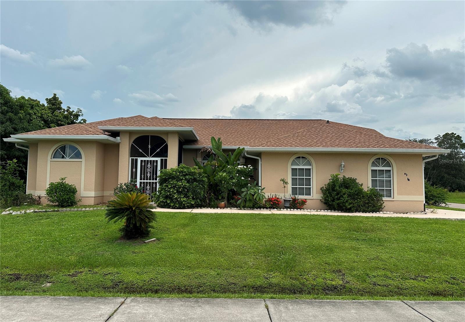 Click the Tour 1 icon above for the NARRATED VIDEO VIRTUAL TOUR, not just the same still photos! Great curb appeal is just a start on this lovely home. Entering through the screened/tiled front porch you are welcomed by decorator front doors that lead to an expansive great room – appearing even larger because of a high cathedral ceiling. The pantry closet is joined by lots of cabinets in the kitchen including a built-in desk. The primary bedroom, the great room, and the breakfast area all have pocketing, sliding glass doors to the lanai which bring into the home our beautiful outdoors. The lanai faces some woods – best view you can have in a subdivision like this. The primary bedroom is graced with a nice seating area (presently housing a large wardrobe) that is the perfect place for an office or a reading area. The primary’s ensuite bathroom is almost too nice to describe – just look at the photos and the video. The guest bathroom features two vanities in separate rooms. Those rooms can be closed off from each other for privacy or left open for convenience. The side-loaded garage allows for a prettier front and makes backing out of the driveway easier and safer. This property comes with a ONE YEAR HOME WARRANTY for the buyer. MUCH MORE INFO is attached – ask your agent for copies, especially the FEATURES LIST and WARRANTY OUTLINE.