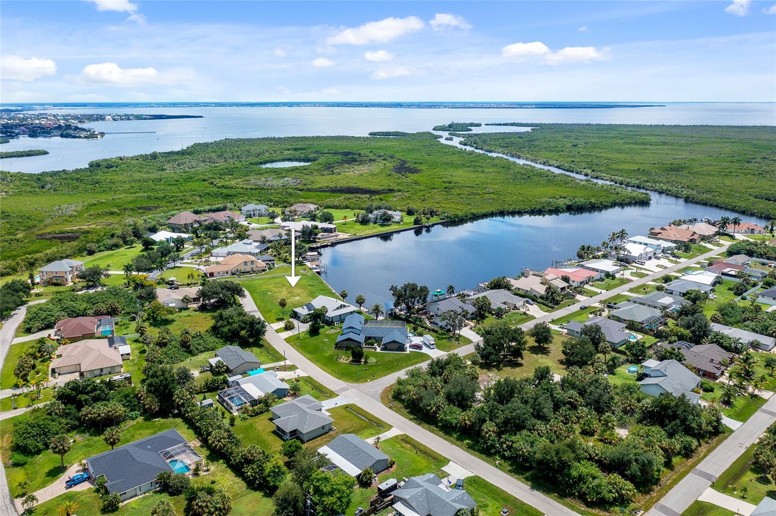 MCGRATH POINT ESTATES! Incredible over 1/2-acre waterfront lot with quick sailboat access to Charlotte Harbor leading to the Gulf of Mexico! Oversized lot in the perfect location to build your luxury estate. Southwestern exposure to enjoy plenty of Florida sunshine and watch gorgeous sunsets. 176 feet of waterfrontage with concrete seawall. Cleared and ready-to-build. Great location close to Port Charlotte Beach Park, Sunseeker Resort and downtown historic Punta Gorda with fine dining, shopping, beautiful parks, award winning fishing and boating, community events and entertainment plus easy access to gulf coast beaches. This is a great opportunity to build the home of your dreams!