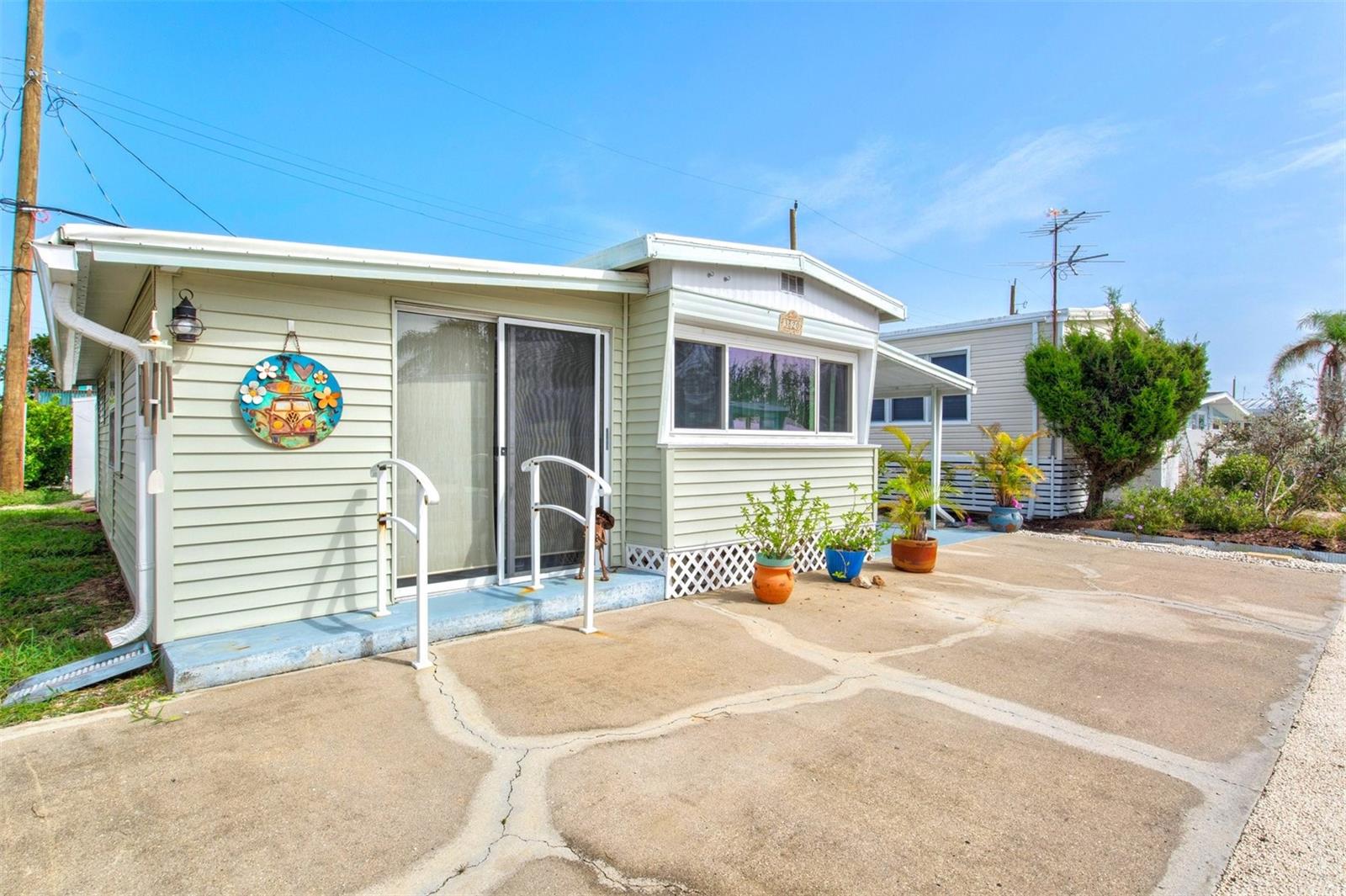 Welcome to your cozy piece of paradise in the highly sought-after Sunny Shores community! This beautifully updated AND TURN-KEY FURNISHED home offers the freedom of NO rental, age, deed or pet restrictions, and best of all – no lot rent. You own the land, giving you full control over your property. Plus, enjoy access to the community boat ramp, making it a dream location for boating enthusiasts. Completely remediated with quality materials following recent storms, this home is move-in ready and built with the future in mind. The open-concept layout features a spacious living room and a modern kitchen with stunning butcher block countertops and brand-new lower cabinets. A versatile bonus room provides the perfect space for a second bedroom, home office, or den. With two generously sized bedrooms and a full bathroom, this home offers a comfortable and practical living space. The screened-in porch invites you to unwind and enjoy Florida’s beautiful weather year-round. Say goodbye to the limitations of traditional communities! Sunny Shores gives you the freedom to live on your terms. For just $80/year, the optional HOA provides access to a clubhouse with fantastic amenities including a fitness room, shuffleboard, pool table, library, and a variety of social activities. Located less than 2 miles from the pristine beaches of Anna Maria Island, and just steps from Sunny Shores Park and Palma Sola Bay, outdoor adventures like fishing, kayaking, and hiking are always within reach. And with Parrot Cove Marina’s boat ramp nearby, exploring the Gulf waters has never been easier. Whether you're looking for a full-time residence, vacation home, or income property, this home offers unlimited short- or long-term rental potential – with no restrictions. Don’t miss your chance to own a slice of the Florida dream. Schedule your showing today and start living the lifestyle you deserve in Sunny Shores!