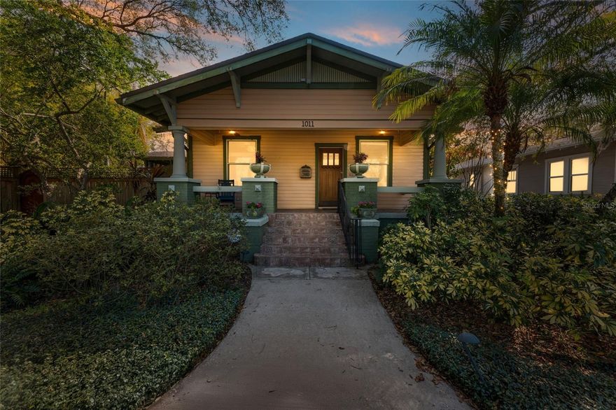This is easily one of the most captivating and unique homes you’ll find in Tampa—full of character, warmth, and thoughtful detail at every turn. Set on an elevated double lot in the heart of Seminole Heights, this 1920s Craftsman bungalow sits along a charming, tree-lined street with wide sidewalks and a welcoming neighborhood feel. Located in historic Evelyn City, the setting is as special as the home itself, with FOUR tucked-away riverfront parks just a short stroll or bike ride from your front door.

From the moment you step onto the classic front porch and enter inside, the home’s authenticity shines through. Original details like rich restored hardwood floors, wood-paneled doors, glass and brass hardware, and detailed trim create a timeless foundation, while carefully selected updates keep everything feeling fresh and functional. The kitchen is both beautiful and practical, featuring warm wood cabinetry with beadboard accents, stone countertops, stainless steel appliances, and a standout gas range with double dishwashers—perfectly blending style with everyday usability.

The layout offers two light-filled secondary bedrooms, a charming vintage-style guest bath, and a private primary suite complete with a cozy sitting area, access to a screened porch and garden, and a spa-like bath with dual vanities and a steam shower.

Step outside and the property truly transforms into a private retreat. The backyard is lush and immersive, surrounded by mature bamboo and tropical landscaping that creates a peaceful, secluded atmosphere. The pool has been completely redone and now serves as a stunning focal point, featuring a freeform design with a heated spillover spa, natural stone decking, and a serene, resort-like feel. A dining gazebo and multiple lounging areas make it perfect for entertaining, while a dedicated astroturf dog run adds everyday convenience.

Additional features include a garage/workshop, a convenient pool bath, ample off-street parking, and a whole-house generator for peace of mind, along with the added benefit of a newer roof. Rounding out the property is a detached two-bedroom, one-bath apartment with its own washer and dryer—ideal for guests, rental income, or a private workspace.

This home is a rare blend of historic charm, modern comfort, and exceptional outdoor living—truly a standout property in one of Tampa’s most beloved neighborhoods, just minutes from top dining, shopping, parks, and everything the city has available!