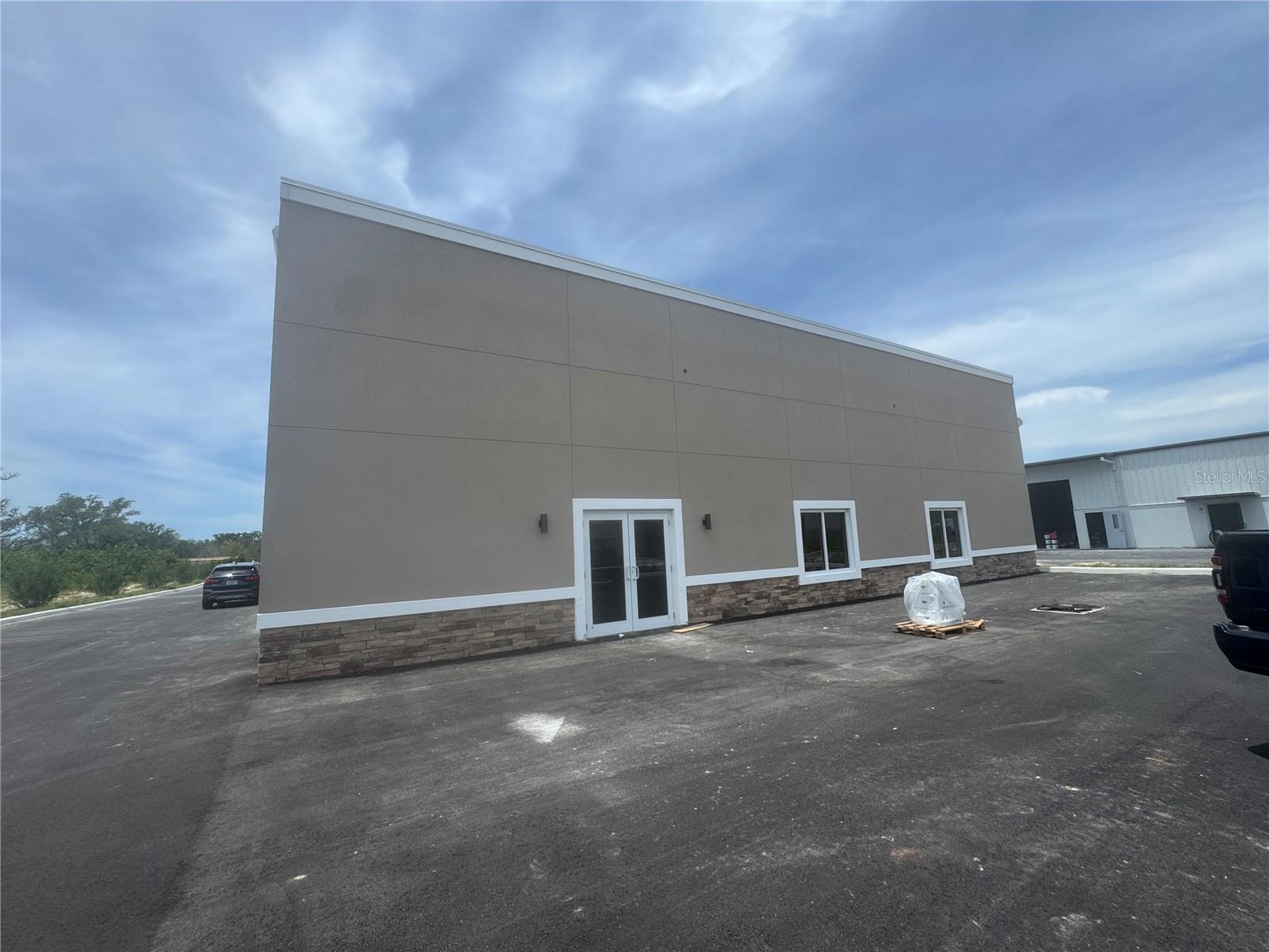 Under Construction. New construction warehouse space available. This 4 tenant building is located in a well-appointed Tarpon Springs industrial park. Unit A is the front space which provides extra visibility, a double retail door entrance, and 2 front facing windows providing some natural light to the space. The space features an ADA restroom at the rear of the space as well as a private office space with VCT floor.