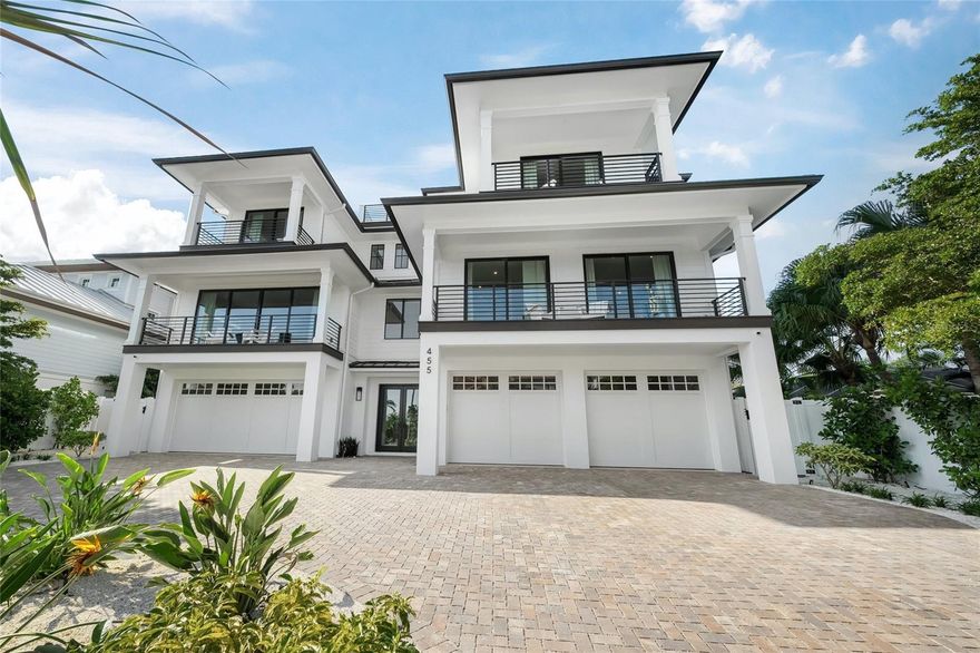 Indulge in Coastal Grandeur at Your Custom-Built fully FURNISHED Lido Key Masterpiece! Welcome to this architectural marvel located in the prestigious and highly sought-after Lido Key neighborhood, where modern elegance meets tropical serenity. Nestled just moments away from the shimmering shores of Lido Key Beach, this custom-designed sanctuary redefines the essence of upscale island living.
Set amidst lush, meticulously curated tropical landscapes, this estate spans 4,702 sqft of pristine living space, crafted with unrivaled attention to detail. The sleek, contemporary façade invites you into a world where luxury and comfort intertwine seamlessly. Upon entering, you're enveloped by a world of opulence with soaring ceilings, custom finishes, and floor-to-ceiling windows that bathe the entire home in natural light. This 6-bedroom, 6-full-bath, and 2-half-bath masterpiece, complete with a den and 4-car garage, is the ultimate retreat for the discerning buyer seeking sophistication and relaxation. Four of the bedrooms come equipped with their own private balconies, offering sweeping views of the lush surroundings and tranquil waters, creating intimate spaces for quiet reflection. The open-concept living area flows effortlessly into a gourmet chef's kitchen, outfitted with state-of-the-art appliances, pristine quartz countertops, and a stunning island designed for both culinary artistry and entertaining guests. Enjoy the convenience of dual washer/dryer units—located on both levels of the home—making laundry as luxurious as the rest of your experience here. The primary master suite offers an unparalleled sense of serenity, with a spa-inspired en-suite bathroom featuring a lavish recessed shower, an elegant freestanding tub, and premium fixtures. Upstairs, a second master suite ensures that family and guests are enveloped in equal comfort and privacy. For those who appreciate alfresco living, the expansive rooftop deck and rear entertainment spaces are perfect for savoring balmy Florida evenings. Whether hosting an outdoor soirée or simply enjoying a sunset cocktail, the options for outdoor relaxation are endless. The resort-style pool and elevated spa offer a private oasis, surrounded by tropical greenery for utmost seclusion. The den, complete with a wet bar, is a sophisticated space ideal for entertaining, while the home’s expansive outdoor kitchen offers everything needed for culinary adventures under the stars. The location couldn’t be more idyllic: just a short stroll from Lido Key Beach and a brief bike ride to the upscale boutiques and fine dining at St. Armands Circle. This residence offers the ultimate coastal lifestyle, perfect for creating cherished family memories or generating substantial rental income. Now is your opportunity to claim a slice of Lido Key paradise. Schedule a private tour and experience the epitome of refined coastal luxury!