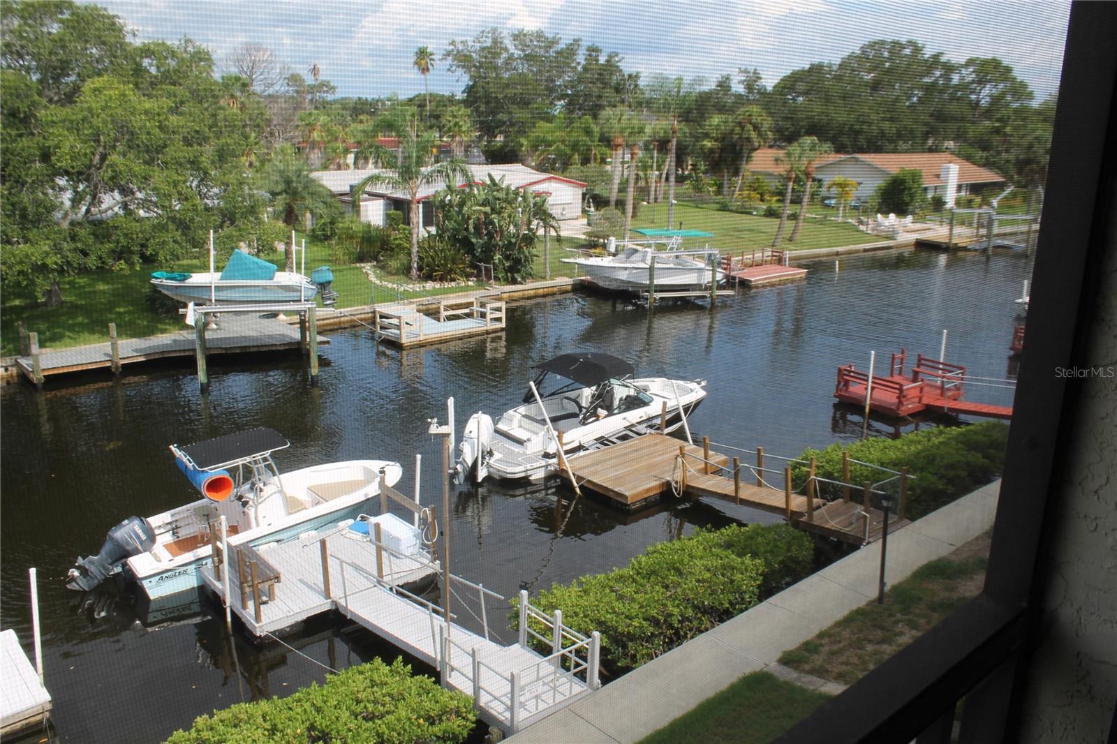 ONLY 150 STEPS TO THE GULF. WATERFRONT SUNRISE & SUNSET VIEWS + PRIVATE BOAT DOCK! If these are the top priorities on your list, then look no further! Relax and enjoy Florida living at its finest, but don’t hesitate as this type of property moves fast – 2/2 Condo in GATED community is guarded 24/7 and comes with amazing amenities including easy in/out parking spot, private pool, tennis/pickle ball court, boat slip, rec center, fitness center, and more! RECENTLY UPDATED featuring upgraded vinyl flooring throughout, gorgeous kitchen equipped with stainless steel appliances, water/ice dispenser, 42" wood cabinets with soft-closure, beautiful granite countertops and breakfast bar. The inviting open floor plan, that makes it an easy transition from kitchen to dining area to living room, is great for entertaining. The elongated space ends with panoramic views of the water, which you can enjoy on your newly screened-in balcony. The owner’s suite offers magnificent sunrises and can fit a king-sized bed comfortably. Along with the generous sized custom closet, spacious bathroom, and separate vanity area, you will feel right at home in this luxurious retreat. The second bedroom easily fits a queen-sized bed with large windows providing sunset sights… you get the best of both views! The closet was recently upgraded with a custom, built-in organization system. There are multiple closets to offer significant storage space with an additional garage locker for larger items! Walking distance to waterfront dining, beaches/parks, medical, and shopping – The location is prime! CALL NOW! SEE NOW!