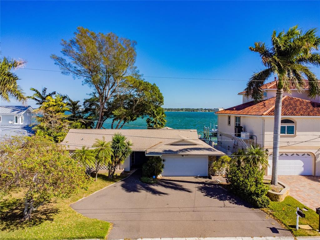PRICED TO SELL FOR BELOW LAND VALUE! Fantastic open waterfront home directly on the Intracoastal Waterway. Situated on one of the most beautiful waterfront communities in Tampa Bay. This is an opportunity to complete the home to your taste. Or build new on this prime location of Belleair Beach. Recent updates include a new sea wall, roof, and flooring. This oasis is any boater’s dream with deep water around the clock and the ability to park a large vessel with rapid boating access to The Gulf of Mexico from your home. Don’t miss this unique opportunity.