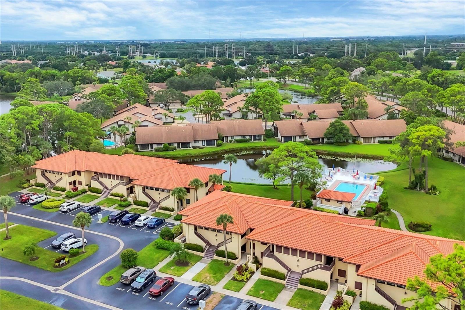 This delightful, turnkey-furnished 2-bedroom, 2-bathroom condo on the GROUND floor in The Meadows is ready for you to move in immediately. Recently updated, the condo boasts laminate wood flooring, tile in the kitchen and bathrooms (no carpet), elegant maple cabinetry, and charming Key West-style countertops in the kitchen. Ceiling fans are featured in both bedrooms and the GLASS SLIDER Florida room with Southern exposure, which also includes electric window shades. The split bedroom layout ensures privacy for you and your guests, with each bedroom having its own updated, ensuite bathroom. Enjoy tranquil views of the lake and pool from this serene retreat, which also offers a new natural gas BBQ grill area by the pool just steps away from the lanai. This property is not in a flood zone and is small dog-friendly (pending association approval), plus there’s a community dog park. Notable features include a walk-in laundry room with a stacked washer and dryer, as well as well-appointed furnishings. The primary bedroom features a king-size bed, beautiful walk-in shower and 2 closets, while the guest bedroom has a queen-size bed. Additional items such as games, dishes, pots and pans, two TVs, and all essential appliances for daily living are included. The condo comes with assigned parking, along with guest parking spaces. Conveniently located within walking distance of Meadows Village Shops, residents can enjoy dining, a spa, massage services, and medical offices, as well as the winter months’ Meadows Farmers Market. Please note that overnight parking of trucks or commercial vehicles is not permitted per association rules. The Meadows community offers a variety of amenities, including walking/biking trails, lakes, a fitness center, ten pickleball courts, a playground, a basketball court, a community pool and hot tub, 24-hour security, fishing, dining options, and a calendar of monthly community events, all included in the association dues. Tennis and golf are available for an additional fee. This condo allows you to move in worry-free, with everything provided at a very reasonable value.