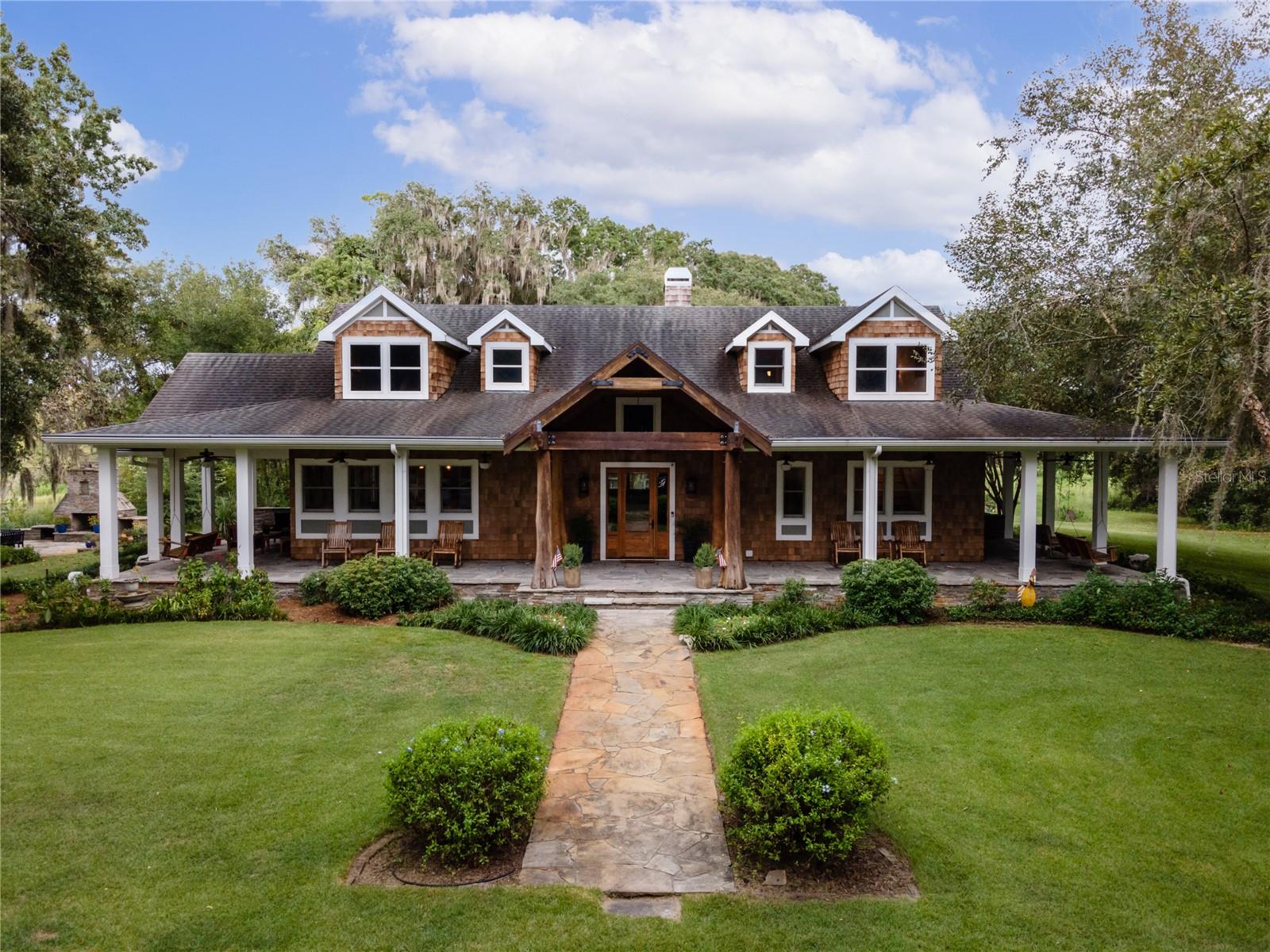 Introducing Quarry Lakes Ranch, a pristine 500-acre retreat located in Bushnell, Florida. This exceptional property features untouched woods, eight picturesque lakes, and a sprawling open pasture, offering a perfect balance of relaxation and recreational activities such as fishing, horseback riding, hunting, and thrilling recreational vehicle/mountain bike routes.
The estate comprises three exquisite homes, starting with the main house. This spacious 3,768 square foot haven boasts a magnificent 1,400+ square foot front porch providing breathtaking views of the shimmering lake. Inside, an open floor plan showcases three charming bedrooms, including a large bedroom hosting multiple beds ideal for guests or a lavish master suite. The rustic yet stylish high-vaulted ceilings and tasteful integration of wood elements create a timeless charm. The main house features a well-appointed kitchen, a convenient gardening/potting shed, and a charming stone patio with an outdoor fireplace.
The guesthouse, built in 1984, offers 1,888 square feet of space and serves as an ideal retreat for family, friends, or as a lucrative vacation/rental property. A spacious front porch treats guests to picturesque views of the expansive pasture and grazing animals.. It includes four tastefully appointed bedrooms, 2.5 baths, a vaulted ceiling living room, and a modern kitchen. Skylights throughout the guesthouse bathe the area in natural light, and a bonus pole barn provides storage space for equipment.
A charming cottage on the property offers intimate accommodations with one bedroom, one full bathroom, and a versatile bonus room, perfect for guests or vacation rentals.
For recreation, Quarry Lakes Ranch features a large-sized pool and hot tub built-in 2020, maintained at the perfect temperature throughout the seasons. The pool house, spanning 2,853 square feet, includes two full bathrooms, an outdoor shower, a kitchenette, a washer/dryer combination, and an entertainment area, ensuring ultimate comfort and convenience. A spacious garage with room for four vehicles and a separate garage for recreational vehicles and equipment are also available. Additionally, there is a structure near one of the lakes that features a tiki bar, outdoor kitchen, and entertainment space. The pool house is equipped with two full bathrooms, a kitchenette, a washer/dryer combination, and an entertainment area, ensuring ultimate comfort and convenience.
The final structure on the property is the barn, offering 2,257 square feet of functional space. It includes an air-conditioned tack room, a half bath, a feed room, and five stalls with automatic water bowls. The fifth stall is larger to accommodate birthing or animals requiring extra care. A cattle pen and chute ensure proper care and handling of livestock.
Quarry Lakes Ranch is a haven for country living, recreation, and entertainment, providing a serene and luxurious retreat for those seeking an extraordinary lifestyle.