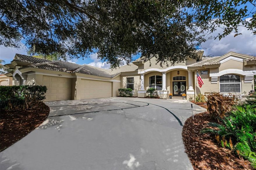 Experience timeless elegance and refined living in this stunning Mark Maconi custom designed residence, perfectly positioned on a serene cul-de-sac overlooking the 8th hole of Lake Jovita’s South Course. This exceptional home combines nearly 3,000 sq ft of sophistication, thoughtful upgrades, and resort-style outdoor living within the prestigious, gated Lake Jovita Golf & Country Club community. From the moment you arrive, the home’s architectural details set the tone - double entry doors, a courtyard-style three-car garage, manicured landscaping highlights the executive curb appeal. Inside, soaring ceilings, abundant natural light, and rich flooring create a warm yet elevated ambiance. Tile flows through the main living spaces, complemented by wood flooring in the dining room, living room, and all bedrooms - no carpet. The open floor plan is anchored by an elegant double-sided fireplace, visible from multiple entertaining spaces, and enhanced by a custom LED color-changing feature wall in the family room. At the heart of the home, the gourmet kitchen offers the perfect blend of beauty and function with solid-surface countertops, a center island, stainless steel appliances, a walk-in pantry and breakfast bar. Additional bonuses are separate laundry room and garage entry drop zone that also provide additional desk/storage. A nearby office/flex room with a closet offers the option of a fifth bedroom, home office, or creative workspace. The luxurious primary suite is a private retreat, boasting double tray ceilings and a spa-like bath complete with a soaking tub, dual vanities, granite surfaces, and a walk-in shower. Showcasing a traditional Florida split floorplan 3 additional spacious bedrooms on the opposite side of the home provide space and comfort for family or guests. With 2 bedrooms tucked away behind the kitchen and the 4th off the family room with a full bathroom with walk in shower and private access to the pool. Step outside to your own private sanctuary. The expansive screened lanai showcases a sparkling pool and spa all framed by peaceful golf course views and the golden glow of Florida sunshine. Whether you’re lounging poolside or entertaining under the stars, this outdoor oasis delivers year-round enjoyment. Living in Lake Jovita means access to an array of world-class amenities, including two championship 18-hole golf courses, a community park with dog run, basketball and pickleball courts, and optional membership access to tennis, fitness, club pool, and social events. With low HOA fees, no CDD, and a location just 5 minutes from I-75, only 35 minutes north of Tampa, this home offers a rare blend of luxury, privacy, beauty, and convenience. Your dream home awaits on the 8th hole—where elegance, comfort, and golf-course living come together effortlessly.