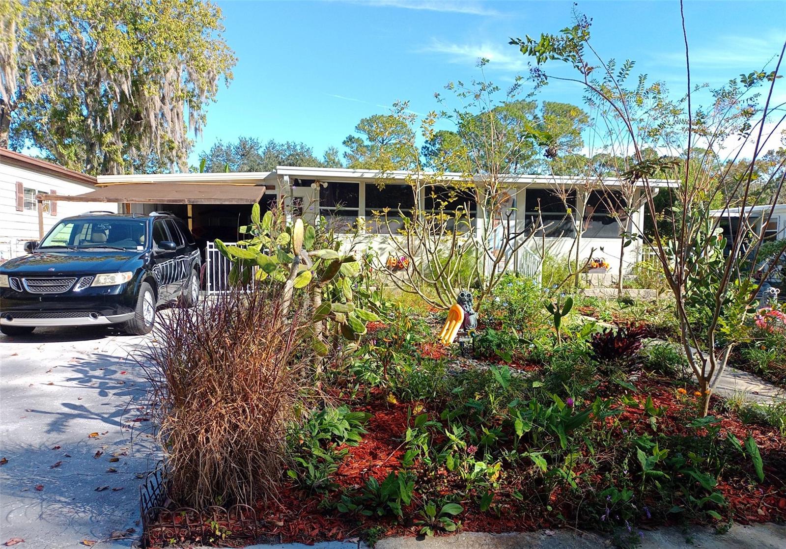 One or more photo(s) has been virtually staged. "River Front Community"- St. Johns River front (Meadowlea on The River), private gated community, with boat ramp and Marina. (no more marinas can be built along the river). We are 250 home, owners of our lots, no age restrictions, pet friendly. Clubhouse with kitchen, pool tables, bingo, dances, events. Storage on site for your toys- boats, Rv's, trailers, cycles. House: 1972 double wide with add -ons, I am 2nd owner. Standing seam metal roof-over, updated electric, plumbing and 4 yr. new AC Mini Split 11/2 ton heat pump, instant propane water heater, paint inside and out, sunscreens, window tint, stained driveway, enclosed carport, wood flooring, kitchen, bathroom. Landscaped , little lawn maintenance. Full bath in shop for after beach, pool, boating, working outside. Home has lots of extra storage, hurricane straps, concrete pillars, is short distance to pool, marina, park, clubhouse. Across street of home, reserve can't be built on. (current home owners insurance, $1,200/yr.) Area Pluses: Low Volusia County. taxes, 3 golf courses 20 min., Sunrail Train station 3 min., I-4 5 min., Orlando 30 min., Daytona 50 min., 2 major Airports 45 min., famous disc golf next door, Historic Downtown Sanford 15 min., Blue Springs 20 min., New City of Debary Downtown site now being built, 3min., famous New Smyrna Beach 45 min. Notes: Included in asking price is- all furniture, decor, appliances, exercise equipment, tools, numerous misc. construction supplies, generator, sound systems, Tv's. Totally ready for move in, enjoy the sunsets down the river, the Sanford Riverboat going by on weekends and our own gators! Owner looking forward to life change retirement overseas. (1 year home warranty)