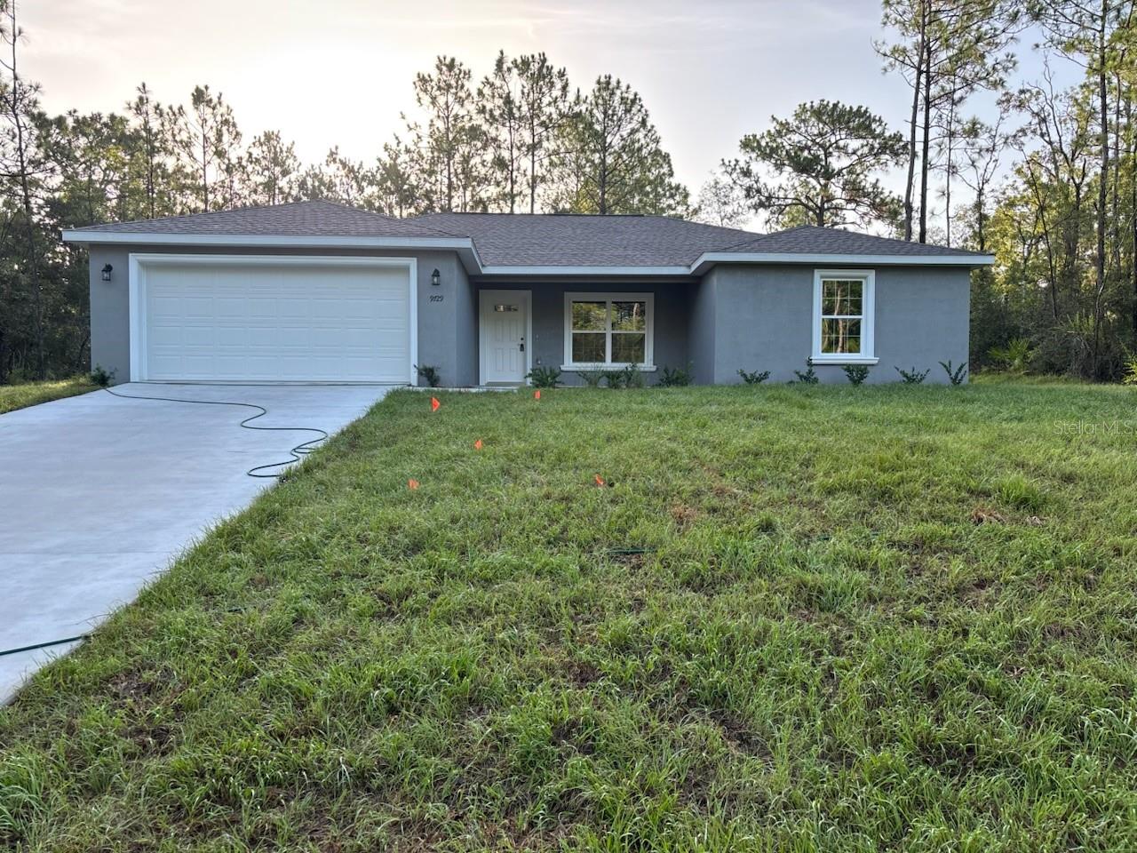 NEW CONSTRUCTION. MOVE-IN READY! This beautiful Marquesas model features 4 bedrooms and 2 bathrooms, spanning 1,646 square feet of well-designed living space. Nestled in a peaceful area of Dunnellon with few nearby neighbors, the home provides a quiet, secluded feel while still being close to town. Built with durable concrete block construction and a 30-year architectural shingle roof, this home also features energy-efficient double-pane windows and comes with a 10-year structural warranty for added peace of mind. Inside, you’ll find a vaulted ceiling in the living room, luxury vinyl plank flooring throughout, and a modern kitchen with stainless steel appliances, granite countertops, custom white shaker cabinets with soft-close drawers, a walk-in pantry, and a classic subway tile backsplash. The master suite features a glass-enclosed shower and upgraded marble-look tile, complemented by the same elegant tile in the guest bath and a convenient tub/shower combination in the main bathroom. A dedicated laundry room features an upgraded cabinet package for extra storage. Enjoy the outdoors from your covered patio and benefit from an attached 2-car garage with opener and remotes. Best of all, there are no HOA fees and the home sits in Flood Zone X, meaning it’s high and dry and does not require flood insurance.