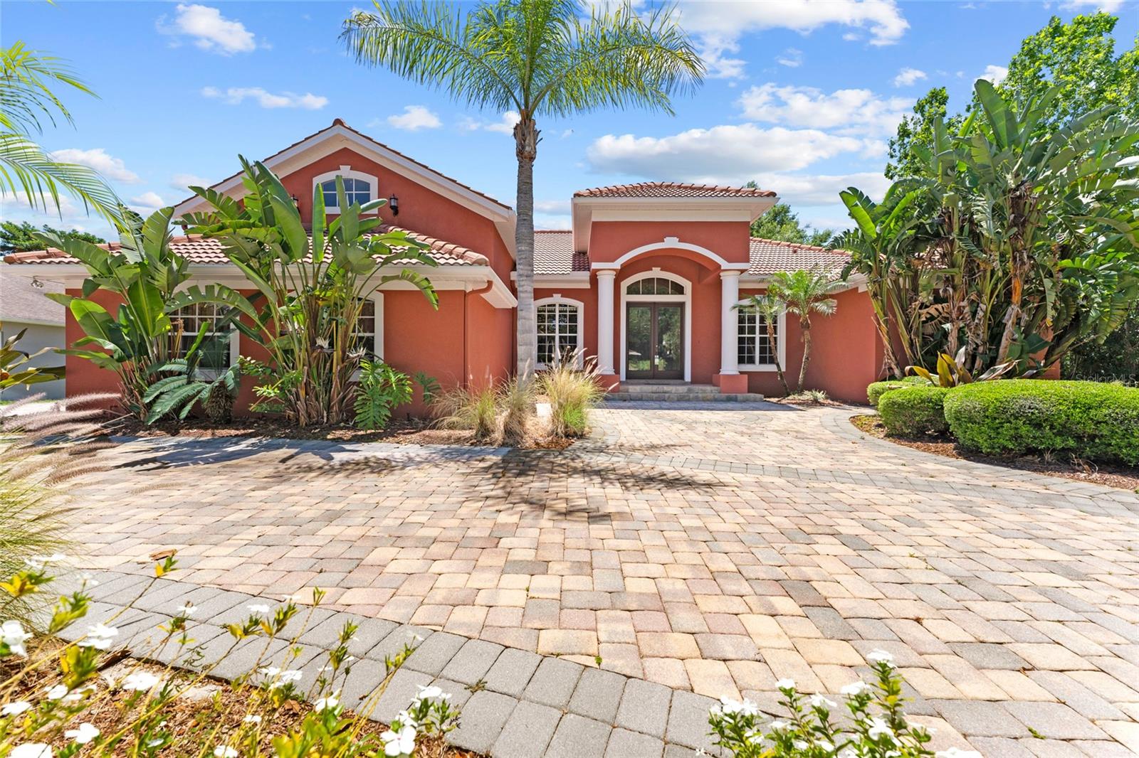 Spectacular Gated Custom Home almost 3500sq ft in the Vineyards! Executive styled quality built custom home that boasts Mediterranean-inspired architecture, highlighted by a charming barrel tile roof, double-door entryway with the largest paver circular driveway in the community. The inside is adorned with elegant archways, crown molding, and tray ceilings. The thoughtfully designed layout features customized angled rooms that enhance the spacious and open feel of the home. The kitchen is a chef's delight, showcasing 42" cherry wood cabinets, thick granite countertops, stainless steel appliances, and a convenient cooking island with a breakfast bar that seamlessly connects to the family room. Enjoy picturesque views from the mitered glass window overlooking the expansive 1100sf "L" shaped lanai with Spanish tile flooring and the tranquil shady backyard with a beautiful oak tree awaiting your picnic bench setup! Experience ultimate comfort and privacy in the master suite, complete with tray cdilings, huge walk-in closet, a luxurious garden tub, a separate shower stall, and double sinks topped with marble accents. Additional highlights include formal living & dining rooms, a built-in buffet for entertaining, a front office/den for easy access, an upstairs bonus room plumbed for a wet bar, a 3 car side-load garage and a community sprinkler well for keeping watering costs down. You can have it all. A close commute without sacrificing quality. This home is conveniently located minutes from the Crosstown Expressway, I-75, I-4 and Hwy 60. It's also within 25 miles of the TPA airport and approximately +-40 minutes from highly ranked St Pete and Clearwater Beaches. Other proximate amenities include the Brandon Mall, restaurants, schools, and hospitals. Don't let this one get away! NOTE: WASHER AND DRYER INCLUDED!