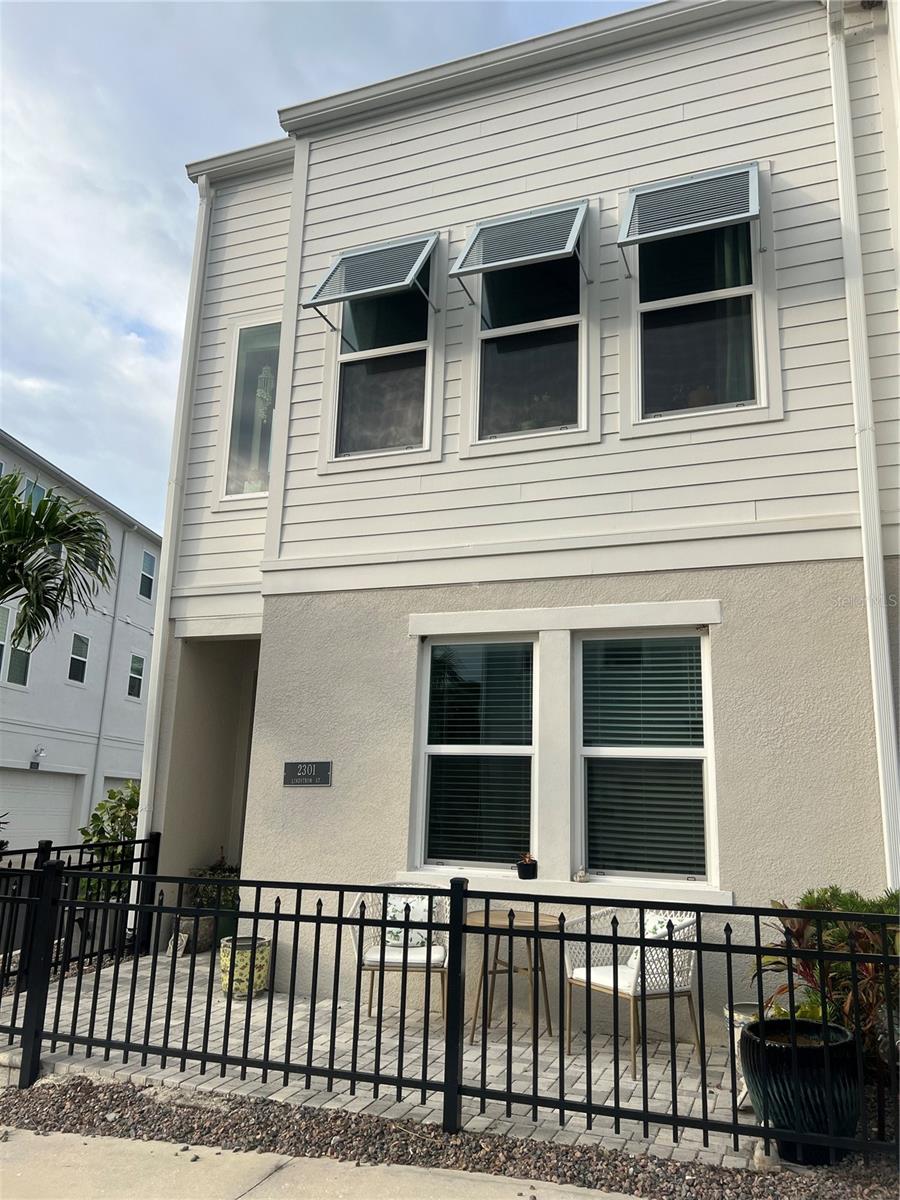 Charming Downtown Rental across from Payne Park and walking distance to Main St Sarasota. Newer construction, 2 bedroom 2 1/2 bath Townhouse with 2 car garage and Community Pool. Owner’s Suite has a walk in closet and En-Suite bath with dual vanities and walk in shower. Guest Suite has En Suite Bath with tub/shower. Kitchen features Quartz Countertops, stainless appliances, breakfast bar, and pantry. End unit has added side windows letting in plenty of natural light, and view of Payne Park. Cute gated front porch, perfect for soaking up the sun, or relaxing with morning coffee or afternoon beverage. This community features a Heated Community Pool and Dog Park, and is close to all the downtown shops and restaurants, along with being a short drive to Siesta Key Beach, Lido Beach, and St Armand’s Circle. This community is just steps to The Legacy Trail, allowing miles of biking, jogging, roller blading, and a quick bike ride to Pompano Pickleball Complex!
