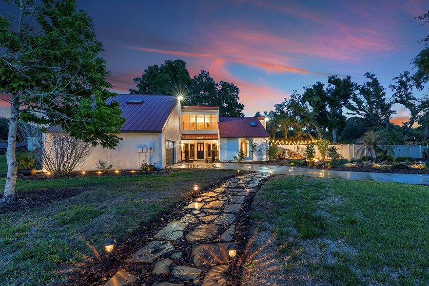 Welcome to Chelsea Woods in Valrico, where space, thoughtful updates, and a peaceful setting come together on over half an acre. This 3-bedroom, 2.5-bath home offers 2,734 square feet of well-designed living space, a 2-car garage, and standout curb appeal with a long driveway, flagstone walkway, mature trees, and a tranquil waterfall feature that flows into a koi pond—all complemented by a striking new metal roof installed in 2025.
Inside, the first floor welcomes you with a spacious living room centered around a stone-encased wood-burning fireplace. Sliding glass doors lead to a nearly 400-square-foot glass enclosed Florida room, complete with a mini-split A/C system, creating a comfortable, year-round extension of your living space. The family room, accessed through updated wood French doors from the living room, also connects to the kitchen through  and dining area—making this space ideal for both everyday living and entertaining.
The kitchen has been beautifully remodeled in 2023 and features solid wood cabinetry, quartz countertops, new disposal, a ceramic tile backsplash, coffee bar, wine refrigerator and updated lighting. High-end appliances include a new refrigerator, Viking electric cooktop with a downdraft hood system in the island, Bosch dishwasher, and a stainless steel under mount single-basin sink.
The first floor also includes the secondary bedrooms, a full bathroom with tub/shower combo and soft-close drawers, a laundry room, and an updated powder room. Upstairs, the private primary suite offers wood flooring, two walk-in closets, and an en-suite bathroom with updated tile,  shower fixtures, and a glass-enclosed shower. Sliding doors lead to a private balcony, creating a peaceful retreat. Also on the second floor is an air-conditioned flex space, perfect for a home office, storage, or hobby room.
Additional upgrades throughout the home include updated interior and exterior paint (December 2025), new lighting in key areas, a Nest thermostat, WiFi-enabled switches, updated laminate flooring in the flex/storage space, and a new water and iron filtration system. The garage has been enhanced with epoxy flooring, a utility sink, and updated lighting.
Step outside to enjoy the spacious pavered patio with fire pit, shaded by mature trees, and a fully fenced backyard—ideal for relaxing or entertaining. An in-ground well system adds efficiency and convenience.
Chelsea Woods offers low HOA fees and no CDD, making this home an exceptional opportunity to enjoy both comfort and value in a well-established Valrico community.