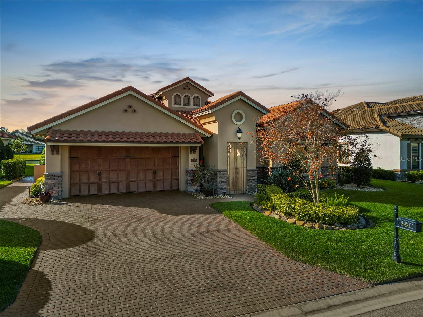 Discover the epitome of luxury living at 2961 Sanctuary Circle, nestled within the prestigious Sanctuary at Grasslands. This exquisite residence offers an expansive and meticulously designed living space.
The home’s open floor plan seamlessly integrates the living, dining, and outdoor recreation space, creating an ideal environment for both entertaining and everyday living. The gourmet kitchen is a chef’s dream, featuring high-end appliances, custom cabinetry, spacious island, coffee bar, wine bar, & breakfast nook. Modern home equipped with SMART technology.
Retreat to the luxurious master suite, which offers a serene water vistas and a spa-inspired bathroom complete with gigantic walk-in closets.
A gated courtyard offers a welcoming threshold before entering the luxurious double doors. Its the perfect spot for a morning coffee or a space for yoga before setting off on your stroll of the picturesque community. The lanai is your private tropical oasis—a beautifully designed pool area perfect for relaxation and hosting gatherings. The outdoor space complements the home’s interior, with 4 glass sliding panels (15 feet) opening out from the great room to the pool area - providing a seamless transition and integration of indoor and outdoor living. The pavered lanai features plenty of outdoor leisure areas overlooking the swimming pool and lake. The soothing waterfall from the fountain in the lake will soothe away your daily stress.
Resident-members enjoy access to top-tier amenities including golf course, tennis courts, community swimming pools, private social club with restaurant, clubhouse, along with the convenience of being near shopping, dining, and entertainment options in Lakeland.