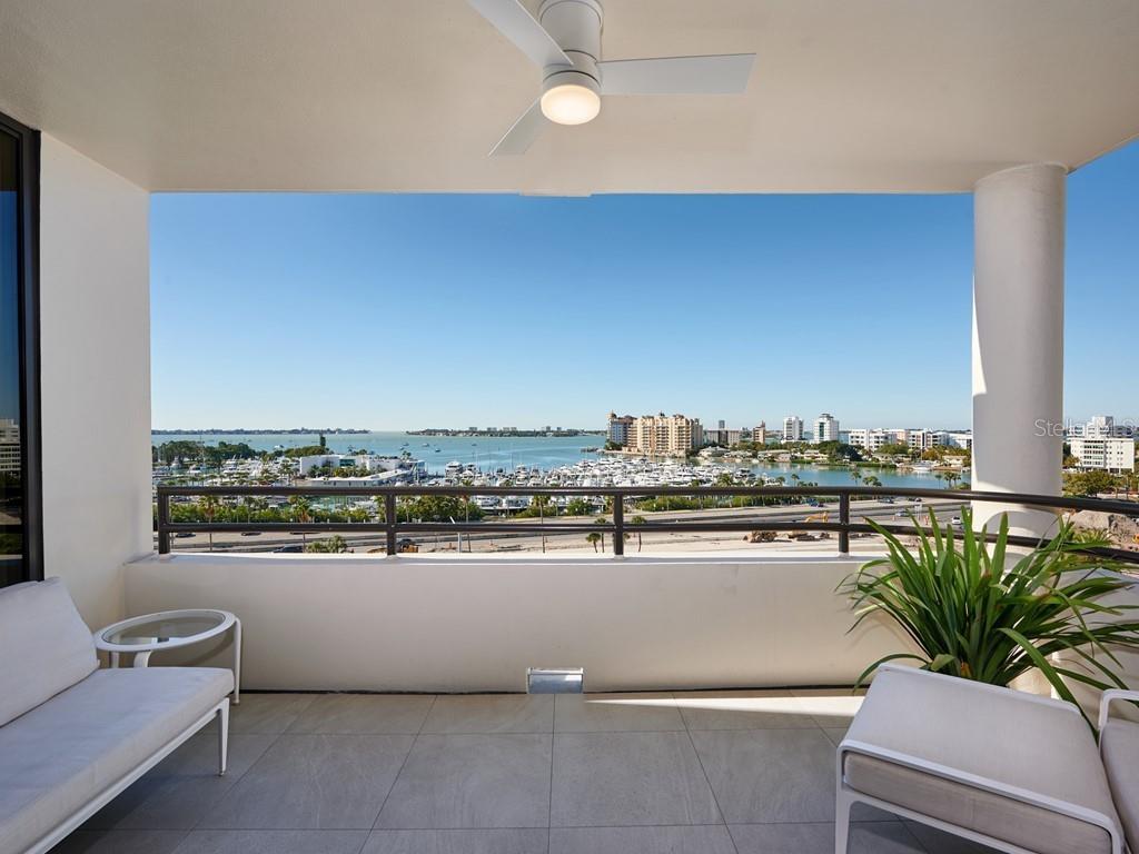 UNOBSTRUCTED AND WIDE-OPEN BAY VIEWS! A downtown Sarasota fully renovated (2020) residence in Bay Plaza offering a den/study, two primary en suites and a private balcony. Views of Sarasota Bay and Big Pass flowing into the Gulf of Mexico can be appreciated from nearly every room. As a bonus the twinkling lights of the city and marina below dance off the water as the sunsets. New (2020) hurricane rated impact sliders overlook the water vistas from the main living area and open to extend entertaining onto the open-air, covered balcony. Modernized throughout with 24” tiled flooring, solid surfaces, large single basin sinks, custom built-ins, CUCCINE RICCI Italian cabinetry, 7-foot Italian doors, J.GEIGER architectural remote operated shades, designer hardware, fine finishes and stylish fixtures. Volume ceilings are accentuated with raised heights in the den/study and kitchen. The ceilings also feature linear and square recessed lighting, LEGRANDE ADORNE switches, outlets, and night lights (all lighting by LIGHT UP YOUR LIFE), remote ‘smart’ ceiling fans, and recessed sprinkler heads. A Quartz waterfall edge defines the peninsular buffet with storage and a SUB-ZERO, under-counter wine fridge. Adjacent the redesigned kitchen was extended with similar Mid-Century modern cabinetry in a wood-grain finish and identical Quartz surfaces. These sleek design elements pair nicely with matte cupboards and wall-hung uppers with task lighting. When closed an inventive coffee bar or appliance station is cleverly concealed. The refrigerator, cooktop, double ovens, and dishwasher (ALL MIELE brand) remain. Through a framed inset glass pocket door is a laundry/hobby room with a service entrance, storage, shelving, a folding or crafters spot, and an included MIELE washer/dryer stack. All baths have floating cabinetry, LED lighted mirrors, TOTO Washlets (electronic bidets), walk-in showers with tile surrounds and glass doors. Two primary suites have exceptional views, built-in bureaus, and one with balcony access. The bigger of the two or Owner’s retreat has extra built-in storage, and a walk-in. A double basin sink with individual faucets, cozy supplemental heater, and a wall-hung lavatory upgrade its private bath. An in-line water heater and whole house water filtration are bonuses. Why wait to remodel or build with so many interruptions & uncertainties on occupancy? Move-in now & enjoy the active social lifestyle that is downtown Sarasota. With ownership in one of the best locations and architecturally significant buildings available, you can enjoy assigned garaged parking for one car, plenty of extra spots, 24hr concierge, 24hr valet, EV charging, an elegant lobby, fitness, hot tub, pool, media room, outdoor grill, storage, & more! Whole Foods, the Theatre & Opera & your choice of excellent restaurants are all close by. This prime location is close to virtually every cultural event that the city has to offer & only minutes to St. Armand’s Circle, Longboat Key, & your choice of any one of Sarasota’s attractive beaches. Furniture is optional. Room Feature: Linen Closet In Bath (Primary Bathroom).