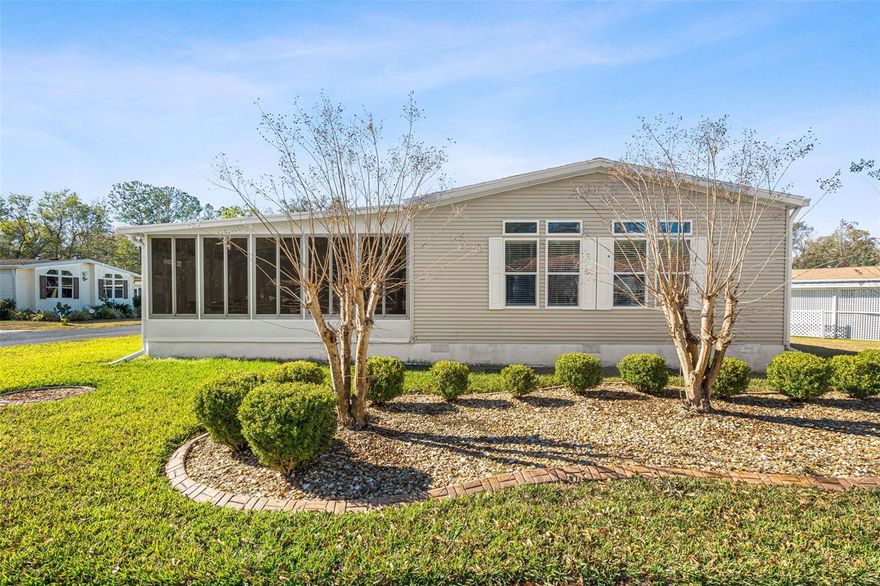 Welcome home to Sylvan Grove, a beautifully maintained 55+ adult land-owned community nestled beneath mature oaks in Brooksville. This spacious and thoughtfully designed residence offers comfort, functionality, and peace of mind in a setting that truly supports relaxed Florida living.
Inside, you’ll find a light-filled open floor plan enhanced by brand new flooring, fresh interior paint, and a newly upgraded electrical panel. Tray ceilings, crown molding, and generous windows create an airy, welcoming atmosphere, while the seamless flow between living, dining, and kitchen spaces makes everyday living and entertaining effortless.
The kitchen is well appointed with abundant cabinetry, ample counter space, bar seating, and clear sightlines to the main living areas. The dining area easily accommodates gatherings, with sliding glass doors providing direct access to the screened porch for indoor-outdoor enjoyment.
The primary suite is exceptionally spacious, offering a peaceful retreat with a large walk-in closet featuring built-in storage and a private ensuite bath complete with a double vanity and a walk-in tiled shower with bench seating. A secondary bedroom with built-in cabinetry functions beautifully as a guest room, home office, or hobby space. Storage is plentiful throughout the home, including a full laundry room with utility sink and cabinetry.
Enjoy morning coffee or evening breezes from the bright screened porch, or take advantage of the oversized covered carport with additional storage space—ideal for vehicles, golf carts, and everyday needs. Some furnishings may be negotiable, offering added flexibility for buyers.
Residents of Sylvan Grove enjoy access to a clubhouse, community pool, shuffleboard courts, and a welcoming neighborhood atmosphere. HOA approval is required for owners and tenants, rentals are permitted with a three-month minimum, pets are allowed with a two-pet maximum (no aggressive breeds), and trailer parking is available at the clubhouse. The monthly HOA fee is just $125.
This move-in-ready home offers easy living, thoughtful upgrades, and a community designed for connection and comfort—an ideal place to enjoy the next chapter of Florida living.