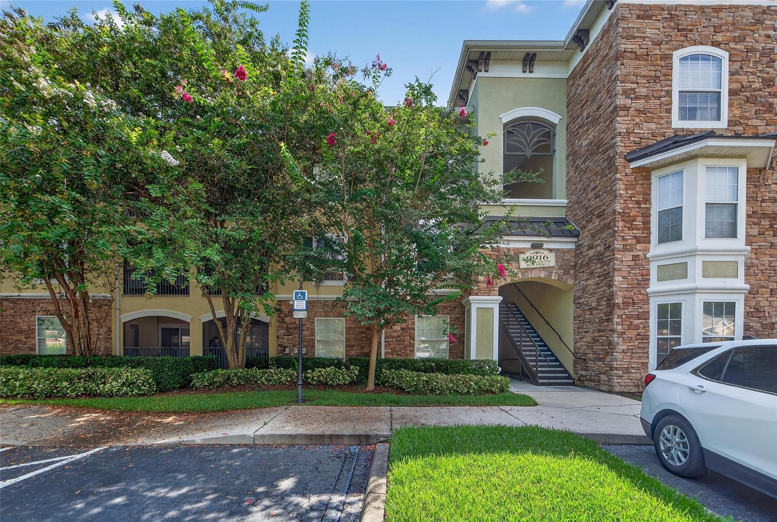 Stylish and centrally located condo with resort style amenities! This beautiful 2-bedroom, 2-bathroom condo is located in the resort amenity rich community of Courtney Palms. This beauty offers a split, open floorplan with LVP throughout and tile in the wet areas. The galley style kitchen offers a functional design with plenty of storage and cook/prep space. There is also a breakfast bar area/dining area that opens to the spacious living room. Off the kitchen you will find a dedicated laundry room and overflow kitchen storage. The primary bedroom is of generous size and offers a walk-in closet as well as a private en-suite bathroom. The secondary bedroom is also of generous size. There is a screened lanai which can be accessed from both the primary bedroom and the living room. This unit also features a computer desk insert, great for the individual who works from home or a great place to complete your homework. This unit is also located within feet of some of the amenities the community has to offer. Community amenities include scenic trails, lakes, fountains, resort-style pool, hot tub, firepits, a fitness center, outdoor grills, a business center (including computers, copier/scanner and wifi), indoor basketball court, indoor racquetball court, pickleball equipment and a clubhouse (with kitchen, seating areas and a theater room). With so much being offered within this community, PLUS being centrally located to shops, restaurants, medical facilities and major highways this is your IDEAL place to call home! APPLY TODAY