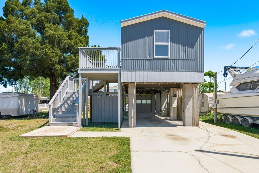 Waterfront, updated, and ready for its new owner!  This elevated 2-bedroom, 1-bath home in Hudson sits on a canal with direct Gulf access, offering a great opportunity to enjoy Florida coastal living at an incredible price. Inside features an open layout with updated cabinetry, appliances, and flooring throughout.  Enjoy the elevated deck overlooking the water, plus added storage space underneath. No HOA, low-maintenance lot, and just minutes to marinas, waterfront dining, and everyday conveniences.  At this price point, living on the water with Gulf access is becoming harder to find, making this a standout opportunity.  Assumable mortgage with private lender available.  Contact agent for details.